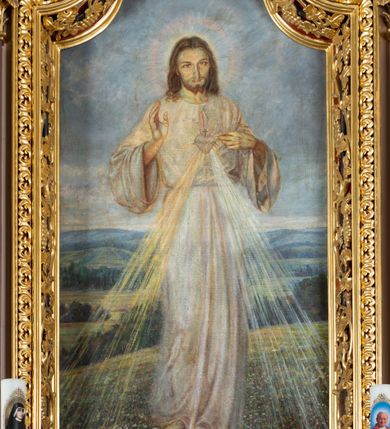 Zdjęcie nr 4: Nastawa ołtarzowa architektoniczna, jednoosiowa i jednokondygnacyjna. Ołtarz prostopadłościenny, drewniany z drewnianą mensą i z marmurowym portatylem. Antepedium w formie prostokąta ujętego profilowaną ramą. W polu płycina o narożach zdobionych płaskorzeźbioną dekoracją roślinną złożoną z liści stylizowanego akantu oraz umieszczonym w polu Barankiem Paschalnym na księdze z siedmioma pieczęciami na czerwonym tle w otoczeniu obłoków i promienistej glorii. Tabernakulum w kształcie prostopadłościennej skrzynki na niskim cokole, flankowane dwiema kolumnami ustawionymi pod kątem, zamknięte od góry prostym belkowaniem, pośrodku nadwieszonym. Na drzwiczkach płycina w kształcie stojącego prostokąta, zamkniętego łukiem półkolistym, ujęta profilowaną ramą, w polu umieszczony jest płaskorzeźbiony kielich z hostią.

Retabulum ustawione na podwójnym cokole, flankowane parą zdwojonych pilastrów i ustawionych przed nimi dwiema kolumnami. Podpory dźwigają wyłamane na osi belkowanie z ustawionymi na bokach rzeźbami aniołków, które trzymają w dłoniach pastorał oraz infułę. Kolumny wspierają się na bazach, trzony mają gładkie i złocone, a kapitele kompozytowe. Po bokach ołtarza na niskich cokołach ustawione są rzeźby: św. Piotra po lewej i św. Pawła po prawej stronie. W polu, w głębokiej wnęce ujętej szeroką, profilowaną ramą umieszczony jest obraz Najświętszego Serca Pana Jezusa. Wnęka od wewnątrz zdobiona płaskorzeźbioną winną latoroślą. Cokół dekorowany jest prostokątnymi płycinami, po bokach wypełnionymi stylizowanym akantem, a pośrodku gablotką z wotami. Belkowanie zdobione wicią z liści akantu oraz rozetami na impostach. W zwieńczeniu monumentalna promienista gloria złożona z wiązek promieni o nierównej długości z monogramem maryjnym na niebieskim tle w polu, otoczonym wieńcem z obłoków. Struktura polichromowana w kolorze jasnego, delikatnego fioletu, płyciny, filary i detale w odcieniu delikatnie ciemniejszym; ornamentyka i profilowania złocone i srebrzone.
