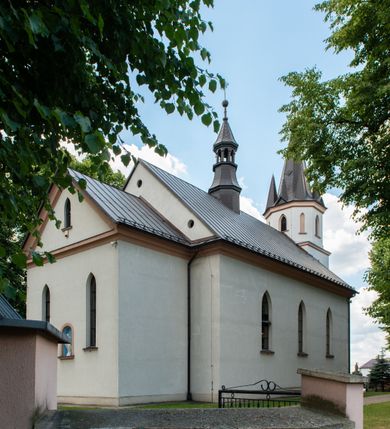 Zdjęcie nr 2: Kościół jest usytuowany w centrum wsi Biały Kościół, na północ od głównej drogi z Krakowa do Olkusza. Teren wokół niego jest otoczony wysokim, kamiennym murem, otynkowanym. Główne wejście znajduje się w murze od zachodu z bramką i dwiema furtkami, flankowanymi przez cztery masywne filary, zdobione ostrołukowymi blendami. Na szczycie filarów ustawione są rzeźby św. Mikołaja i św. Stanisława oraz dwa wazony płomieniste po bokach. Na południowy zachód od kościoła wybudowana jest w ogrodzeniu kaplica. Ponadto w murze są jeszcze trzy wnęki, przykryte daszkami, w których umieszczone są figury.

Kościół jest orientowany, murowany, otynkowany. Wnętrze świątyni tworzy niewielkie, prostokątne, jednoprzęsłowe prezbiterium zakończone prostą ścianą i nakryte pozornym sklepieniem krzyżowo-żebrowym. Nawa jest szersza, na planie prostokąta, nakryta drewnianym stropem z kasetonami, oddzielona od prezbiterium szeroką ostrołukową arkadą w ścianie tęczowej. Od południa do prezbiterium przylega założona na planie prostokąta zakrystia ze sklepieniem beczkowym (pozostawiona ze starego kościoła). Do tej części wzdłuż południowej ściany nawy przylegają kruchta oraz nowo wybudowana druga zakrystia. Na zachodniej ścianie nawy chór muzyczny, dostępny klatką schodową od strony nawy.

Nawę oświetlają umieszczone w południowych i północnych ścianach prostokątne, zamknięte ostrołukowo, rozglifione okna. Na ścianie północnej trzy, a na południowej dwa oraz jedno mniejsze, usytuowane pośrodku nawy nad kruchtą. W prezbiterium są dwa okna na ścianie wschodniej. Wszystkie otwory okienne w kościele wypełnione są witrażami. Do świątyni prowadzą trzy wejścia: główne od strony zachodniej, drugie przez zakrystię od strony wschodniej oraz trzecie przez kruchtę od południa. Wejście główne prowadzi poprzez dwuskrzydłowe drzwi z kruchty pod wieżą. Drzwi między kruchtą a nawą główną są dębowe, przeszklone; za nimi zamocowana jest metalowa krata. 

W zewnętrznej elewacji kościoła widoczny jest niewysoki, kamienny cokół, wykonany z regularnych ciosów kamienia. Prezbiterium niższe od nawy. We wschodniej ścianie, pomiędzy dwoma oknami znajduje się niewielka wnęka, zakończona łukiem półkolistym z figurą Matki Boskiej w polu; powyżej w trójkątnym szczycie umieszczone jest niewielkie, wąskie okienko zakończone łukiem ostrołukowym. Elewacje są bez podziałów architektonicznych. Do zachodniej fasady kościoła dostawiona jest założona na planie kwadratu trójkondygnacyjna wieża-dzwonnica. Poszczególne kondygnacje ustawione są na niskich cokołach i zamknięte profilowanymi gzymsami. W dolnej kondygnacji na osi kościoła, prostokątne wejście do kruchty zaakcentowane rozglifionym portalem w kształcie ostrołukowej arkady i dwustopniowymi schodami. W drugiej kondygnacji ostrołukowe okno zamknięte parą ostrołukowych blend, połączonych jednym parapetem, od góry zamknięte dekoracyjnym trójarkadkowym fryzem. Trzecia kondygnacja ośmioboczna, w każdej ze ścian naprzemiennie ostrołukowe okno lub blenda. Całość nakryta ośmiobocznym, smukłym dachem wieżowym, zakończonym krzyżem osadzonym na kuli; u dołu artykułowanym ośmioma, małymi wieżyczkami. Po bokach wieży, na ścianie zachodniej nawy dwie prostokątne blendy, zamknięte ostrołukowo. Prezbiterium i nawa przykryte stromymi dachami dwuspadowymi. Wieżyczka na sygnaturkę ośmioboczna z latarnią. 

