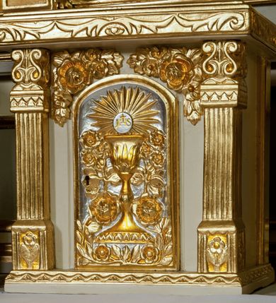 Zdjęcie nr 4: Ołtarz przyścienny, architektoniczny z murowaną mensą z kamiennym portatylem, antepedium z chrystogramem. Na mensie prostopadłościenne tabernakulum, ujęte pilastrami zwieńczonymi gzymsem, z drzwiczkami zakończonymi łukiem koszowym, na których kielich z hostią ujętą  kwiatami róż. Nastawa ołtarzowa jednokondygnacyjna, jednoosiowa ze zwieńczeniem. Retabulum ujęte parą kanelowanych filarów o korynckich głowicach, ustawionych na ukośnie dostawionych cokołach. Podpory ustawione na tle kanelowanych pilastrów wspierają ukośne odcinki belkowania zamknięte wydatnym gzymsem. Zwieńczenie o wklęsłych bokach, zamknięte łukiem nadwieszanym. 
Pole środkowe w formie prostokątnej wnęki z uskokiem u dołu, zamkniętej łukiem nadwieszonym. Wnęka ujęta ażurową ramą formowaną ze zwiniętych liści akantu, wewnątrz obraz z przedstawieniem Najświętszego Serca Jezusa. Antepedium drewniane, ujęte profilowaną ramą, pośrodku aplikowany hierogram. W zwieńczeniu medalion z rzeźbioną gołębicą Ducha świętego w promieniach. Pola cokołów zdobione płycinami ze zwiniętymi liśćmi akantu, w partii fryzu aplikowane rozety. Po bokach retabulum uszaki formowane z ornamentu kandelabrowego. Na gzymsie para rzeźbionych, uskrzydlonych aniołków. Całość struktury ołtarza malowana w odcieniach szarości, detal architektoniczny i profilowania pozłacane.
