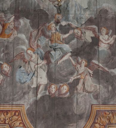 Zdjęcie nr 11: Polichromia umieszczona na stropie nawy głównej. W polu środkowym scena Wniebowzięcia Najświętszej Marii Panny umieszczona w kwadratowej ramie o bokach zamkniętych łukami nadwieszonymi. Rama profilowana, zdobiona rzędem pojedynczych liści. Matka Boska unosząca się na obłokach z szeroko rozłożonymi na boki rękami, prawą wzniesioną do góry. Twarz owalna z długim nosem, silnie zaciśniętymi ustami i dużymi oczami, skierowanymi ku górze. Włosy jasne, kręcone, schowane pod żółtym welonem, którego jeden koniec rozwiany jest wzdłuż prawej ręki. Matka Boska ubrana jest w szeroką, różową suknię, przewiązaną w talii pomarańczową tasiemką oraz błękitny płaszcz, założony za lewe ramię i rozwiany z tyłu. Nad głową Matki Boskiej aniołki unoszą insygnia królewskie: koronę, berło, a także gałązkę białej lilii. Poniżej grupy aniołów podtrzymujące obłoki. Dokoła ramy bujne sploty różnokolorowego akantu przeplecionego karbowaną wstęgą, owijające również ramę ze sceną Wniebowzięcia. W dolnej części ukazane są ponadto dwa anioły podtrzymujące białą wstęgę z napisem: „ASSVMPTA EST MARIA IN COELVM, GAV, / DENT ANGELI, LAVDANTES BENEDICVNT / DOMINVM.” Z kolei z drugiej strony stropu umieszczony jest owalny medalion, obwiedziony liśćmi wawrzynu, w polu którego umieszczone jest czerwone godło zakonu Bożogrobowców oraz małe uskrzydlone główki aniołków. Powyżej na białej wstędze umieszczony jest napis: „SVB HOC SIGNO.”, a poniżej: „RESTAVRATVM A(NN)O (DOMINI) 1714 / Die 14 Aug(st)”. Całość stropu obwiedziona jest dookoła pasem przeważnie prostokątnych kasetonów, wypełnionych różnokolorowymi liśćmi akantu, a także od zewnątrz szerokim pasem dekoracyjnym z brązowych liści wawrzynu. Pasy na bokach wyłamane półkolistymi wypustkami, w których umieszczone są duże muszle palmetowe. Kolorystyka stonowana, jasna z przewagą błękitu i czerwieni.