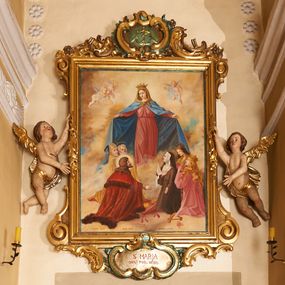 Zdjęcie nr 1: Obraz w formie stojącego prostokąta, ujęty profilowaną ramą, dekorowaną szczytem utworzonym z rocaille'owego kartusza z monogramem Marii w polu, flankowanym rocaille'm i kwiatami, podtrzymywanym w narożach konsolami. U dołu ramy podwieszenie utworzone z rocaille'owego kartusza z napisem „S(ANTA) MARIA / ORA PRO NOBIS”, ujęte rocaille'm i konsolami w narożach. Po bokach ramę trzymają nadlatujące putta. W centralnej części obrazu Matka Boska ukazana w pozycji stojącej pośród obłoków, z pochyloną głową i rozłożonymi na boki rękami podtrzymującymi płaszcz. Ubrana jest w różową suknię, przepasaną w talii, na ramionach ma obszerny, niebieski płaszcz, wokół głowy zawiązaną jasnobrązową chustę, na głowie koronę otwartą. W dolnej części kompozycji ukazane dwie grupy klęczących świętych, zwróconych do wewnątrz. Po lewej tronie św. Piotr. św. Stanisław i św. Stefan (?). Na pierwszym planie św. Stefan ukazany z profilu, z wyciągniętą w przód prawą ręką. Okolony jest krótką brodą i długimi, brązowymi włosami, ubrany w czerwony płaszcz królewski, ze złoconym wzorem, obszyty futrem. Przed nim na różowej poduszce z chwostami leży korona i jabłko królewskie. Obok niego św. Stanisław pozbawiony brody, w stroju biskupim, w żółtej kapie i infule oraz św. Piotr ukazany jako strzec, okolony siwymi włosami i brodą, w żółtym płaszczu. Po prawej stronie obrazu klęczą św. zakonnica, św. Katarzyna Aleksandryjska i św. Elżbieta Węgierska. Zakonnica ubrana jest w brązowy habit i welon oraz białą podwikę, prawą ręką przytrzymuje białą flagę, lewą wyciąga w bok. Obok niej klęczy św. Katarzyna z rekami złożonymi w geście modlitwy, o długich jasnych włosach. Ubrana jest w różowy płaszcz, na głowie ma koronę otwartą. Obok niej leży fragment koła. Za nimi postać św. Elżbiety, która podtrzymuje kwiaty róż. Ubrana jest w zielony płaszcz, na głowie ma czarny welon i koronę otwartą. Scena ukazana na tle jasnobłękitnego nieba wypełnionego żółto-brązowymi obłokami. W górnej części obrazu ukazane trzy putta. W dolnej części obrazu napis: „FUNDATORZY / MYSLIWIEC LUDWIK. IGLAR MACIEJ. GURCZYK PAWEŁ”. W prawym dolnym narożu obrazu sygnatura: „MAL(OWAŁ) KÛC ANTONI / 1932.”
