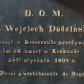 Zdjęcie nr 1: Epitafium w formie tablicy w kształcie leżącego prostokąta, ujętej profilowaną, złoconą ramą. Na czarnym tle złocony napis 
„D(EO) O(PTIMO) M(AXIMO) / X(iądz) Wojciech Dudziński / Expozyt w Krzeczowie przeżywszy / lat 52 umarł w Krakowie / 24go stycznia 1904 r(oku) / Prosi o westchnienie do Boga."