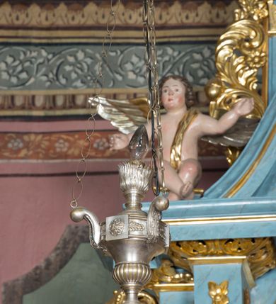 Zdjęcie nr 3: Pełnoplastyczne figury uskrzydlonych aniołków ustawionych przeciwstawnie. Postaci zostały ukazane w pozycji siedzącej, z uniesionymi wysoko rękoma i skrzyżowanymi nogami. Biodra osłonięte wąską, złota szarfą przerzuconą przez ramię. Twarze owalne, pełne, okolone puklami brązowych włosów. Karnacje ciała w naturalnym, jasnokremowym odcieniu, policzki zaróżowione.