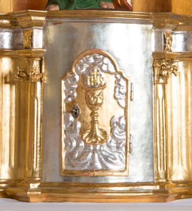 Zdjęcie nr 3: Ołtarz architektoniczny, jednokondygnacyjny, jednoosiowy ze zwieńczeniem. Ołtarz jest prostopadłościenny, z drewnianą mensą. Retabulum osadzone jest na niewysokim, zryzalitowanym cokole. Część środkową nastawy ujmuje para kolumn o korynckich kapitelach, ustawionych na tle zdwojonych pilastrów. Podpory wspierają wyłamujące się ponad nimi belkowanie przerwane w partii architrawu i fryzu. Część środkowa zaaranżowana jest w formie trójbocznej niszy o wykroju zamkniętym łukiem półkolistym, ujętej prostokątną płyciną. Zamknięte trójkątnie zwieńczenie ujęte jest parą pilastrów wspierających gzyms wieńczący. Dodatkowo po bokach znajduje się para niewysokich cokolików oraz przerwany, wklęsły przyczółek. Środkowa płycina antepedium zdobiona jest polichromowanym monogramem maryjnym, ujętym wieńcem kwiatów, płyciny po bokach zdobią wazony z kwiatami. W partii fryzu retabulum oraz na kapitelach pilastrów w zwieńczeniu są motywy rozet. Szczyt zwieńczenia jest w formie ażurowego ornamentu stylizowanej wici roślinnej, po bokach para płomienistych wazonów. W niszy części środkowej retabulum jest figura św. Józefa, w zwieńczeniu obraz w kształcie stojącego prostokąta o ściętych górnych narożach z wizerunkiem św. Antoniego Padewskiego. Na cokolikach ujmujących zwieńczenie usytuowana jest para figur siedzących aniołków.

Struktura ołtarza jest marmoryzowana w odcieniach kremu, beżów i zieleni, detal architektoniczny oraz ornamentyka są złocone.      
