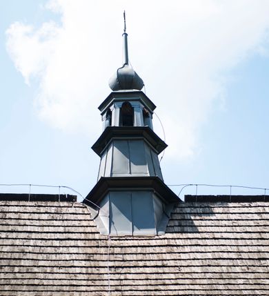 Zdjęcie nr 29: Kościół orientowany, drewniany, na podmurowaniu, o konstrukcji zrębowej, z wieżą o konstrukcji słupowo-ramowej. Składa się z prostokątnej nawy, do której od wschodu przylega węższe prezbiterium zamknięte trójbocznie. Do niego od północy dobudowano prostokątną zakrystię. Do nawy od zachodu przylega wieża na rzucie kwadratu, o ścianach pochyłych, rozdzielona na kondygnacje daszkiem; zwieńczona nadwieszoną izbicą szalowaną pionowymi deskami wyciętymi dołem w ozdobną koronkę; w ścianach izbicy po dwa małe okienka. 
Kościół jednonawowy, z węższym prezbiterium oddzielonym ścianą tęczową. Otwór tęczowy podwójny, górny mniejszy, w strefie sklepień, dolny większy, wycięty w zrębie. Na podniebiu dolnego łuku napis „TEN KOŚCIÓŁ ZAŁOŻONY RP 1789 BENEDYKOWANY RP 1792 MALOWANY RP 1930”. Ściany gładkie, pokryte dekoracją malarską imitującą detale architektoniczne: kolumny, belkowanie, obramienia okien, plafony wypełnione rzeźbiarską dekoracją; między nimi postacie świętych. W nawie od zachodu chór muzyczny wsparty na dwóch, profilowanych słupach, z parapetem wybrzuszonym pośrodku. Nawa i prezbiterium nakryte pozornym sklepieniem kolebkowym z płaskimi odcinkami stropowymi po bokach. 
W nawie głównej cztery okna, w prezbiterium dwa, wszystkie w kształcie stojącego prostokąta; w dolnej kondygnacji wieży dwa okna w kształcie leżącego prostokąta. Wejście główne od zachodu, kolejne od południa, oba portale zamknięte od góry łukiem „w ośli grzbiet”; portal z prezbiterium do zakrystii.  
Kościół obiegają soboty, czyli rodzaj podcieni, zamkniętych wokół wieży, otwartych na pozostałej długości; z kruchtami od zachodu i od południa; cztery kwadratowe okienka w sobotach od zachodu. 
Ściany na zewnątrz kościoła pobite deskami. Nad nawą główną dach dwuspadowy, nad prezbiterium wielopołaciowy, przedłużony od północy na zakrystię. Na dachu nawy zwężająca się ku górze wieżyczka na sygnaturkę, która przechodzi w latarnię o cebulastym zakończeniu. Wieżę zachodnią wieńczy hełm złożony z niskiego dachu namiotowego i nasadzonej na niego bani z kulą i krzyżem. Soboty nakryto dachem pulpitowym, wygiętym przy ścianie wschodniej zakrystii łukowo ku górze po to, aby lepiej ją doświetlić. Dachy kryte gontami, hełmy wież blachą. 
