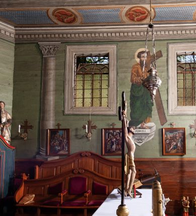 Zdjęcie nr 53: Kościół orientowany, drewniany, na podmurowaniu, o konstrukcji zrębowej, z wieżą o konstrukcji słupowo-ramowej. Składa się z prostokątnej nawy, do której od wschodu przylega węższe prezbiterium zamknięte trójbocznie. Do niego od północy dobudowano prostokątną zakrystię. Do nawy od zachodu przylega wieża na rzucie kwadratu, o ścianach pochyłych, rozdzielona na kondygnacje daszkiem; zwieńczona nadwieszoną izbicą szalowaną pionowymi deskami wyciętymi dołem w ozdobną koronkę; w ścianach izbicy po dwa małe okienka. 
Kościół jednonawowy, z węższym prezbiterium oddzielonym ścianą tęczową. Otwór tęczowy podwójny, górny mniejszy, w strefie sklepień, dolny większy, wycięty w zrębie. Na podniebiu dolnego łuku napis „TEN KOŚCIÓŁ ZAŁOŻONY RP 1789 BENEDYKOWANY RP 1792 MALOWANY RP 1930”. Ściany gładkie, pokryte dekoracją malarską imitującą detale architektoniczne: kolumny, belkowanie, obramienia okien, plafony wypełnione rzeźbiarską dekoracją; między nimi postacie świętych. W nawie od zachodu chór muzyczny wsparty na dwóch, profilowanych słupach, z parapetem wybrzuszonym pośrodku. Nawa i prezbiterium nakryte pozornym sklepieniem kolebkowym z płaskimi odcinkami stropowymi po bokach. 
W nawie głównej cztery okna, w prezbiterium dwa, wszystkie w kształcie stojącego prostokąta; w dolnej kondygnacji wieży dwa okna w kształcie leżącego prostokąta. Wejście główne od zachodu, kolejne od południa, oba portale zamknięte od góry łukiem „w ośli grzbiet”; portal z prezbiterium do zakrystii.  
Kościół obiegają soboty, czyli rodzaj podcieni, zamkniętych wokół wieży, otwartych na pozostałej długości; z kruchtami od zachodu i od południa; cztery kwadratowe okienka w sobotach od zachodu. 
Ściany na zewnątrz kościoła pobite deskami. Nad nawą główną dach dwuspadowy, nad prezbiterium wielopołaciowy, przedłużony od północy na zakrystię. Na dachu nawy zwężająca się ku górze wieżyczka na sygnaturkę, która przechodzi w latarnię o cebulastym zakończeniu. Wieżę zachodnią wieńczy hełm złożony z niskiego dachu namiotowego i nasadzonej na niego bani z kulą i krzyżem. Soboty nakryto dachem pulpitowym, wygiętym przy ścianie wschodniej zakrystii łukowo ku górze po to, aby lepiej ją doświetlić. Dachy kryte gontami, hełmy wież blachą. 
