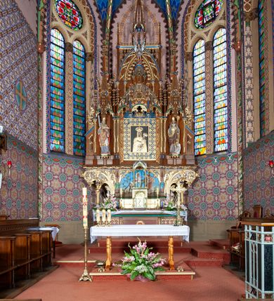 Zdjęcie nr 7: Kościół jest położony na północny-zachód od centrum miejscowości, na placu otoczonym ceglanym murem na podmurówce z murowanymi słupkami, nakrytym blaszanym daszkiem. Główne wejście na plac kościelny prowadzi przez pseudobastionową bramę, flankowaną dwiema pseudowieżyczkami oraz dwiema furtkami. Kościół jest budowlą założoną na planie krzyża łacińskiego, murowaną z cegły, orientowaną, jednonawową z transeptem, prezbiterium zakończonym trójbocznie i wieżą. Od północnej strony kościoła prostokątna zakrystia, od południa w narożniku korpusu i prezbiterium niewielkie kruchty. 

Wnętrze artykułowe ostrołukowymi arkadami wspartymi na filarach. Korpus sześcioprzęsłowy, nakryty sklepieniem krzyżowo-żebrowym; prezbiterium dwuprzęsłowe, węższe od korpusu ze sklepieniem gwiaździstym. Chór muzyczny wsparty na trzech arkadach. W kościele duże okna pseudomaswerkowe w kształcie stojących prostokątów, zamkniętych ostrołukowo, wypełnione witrażami.

Na zewnątrz elewacje ceglane z kamiennym cokołem, zamknięte kamiennym gzymsem podokapowym. Od fasady po lewej stronie dostawiona masywna wieża na planie kwadratu, czwórkondygnacyjna. W dolnych kondygnacjach niewielkie okienka, trzecia kondygnacja najwyższa, a w niej wysokie prześwity okienne z biforiami, wyżej zegary na każdej ścianie wieży. Ostatnia kondygnacja najwyższa z otworami okiennymi w kształcie leżących prostokątów, zamkniętych odcinkowo, wypełnionych podwójnymi biforiami. Wieża nakryta ostrosłupowym hełmem z analogicznymi czterema mniejszymi hełmami w narożach. Po prawej stronie fasady kruchta wejściowa do kościoła założona na planie prostokąta z portalem od zachodu, nakryta daszkiem jednospadowym, od południa zwieńczonym kamiennym szczytem schodkowym. Portal wysunięty przed lico kruchty, w polu ostrołukowa arkada z tympanonem przedstawiającym Chrystusa spotykającego Marię Magdalenę. Portal zamknięty trójkątnym szczytem, którego pole wypełnione jest rzeźbioną dekoracją z liści i owoców winnego grona oraz krzyża łacińskiego pośrodku. Za kruchtą ściana zachodnia kościoła zamknięta trójkątnym szczytem schodkowym, wypełnionym blendami. Analogiczne szczyty na zakończeniu ramion transeptu oraz na zakończeniu korpusu nawy kościoła od strony wschodniej. Nad skrzyżowaniem ramion transeptu umieszczona jest wieżyczka na sygnaturkę. Do świątyni prowadzą też dwa mniejsze wejścia od strony południowej przez kruchty oraz trzecie przez zakrystię. Korpus nakryty wysokim, dwuspadowym dachem. Ramiona transeptu nakryte osobnymi dachami dwuspadowymi o kalenicy niższej niż dach korpusu. Na zewnątrz kościół oszkarpowany. 