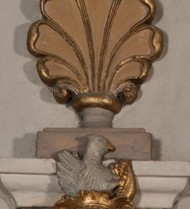 Zdjęcie nr 63: Kaplica pod wezwaniem Najświętszej Marii Panny i Wszystkich Świętych przylega do kościoła od południa, do pierwszego przęsła nawy, z którą komunikuje się za pomocą półkoliście zamkniętej arkady. Zbudowana została na planie kwadratu. Nakryto ją półsferyczną czaszą na pendentywach i zwieńczono latarnią. Wnętrze artykułowano za pomocą ślepej arkady z pilastrami i archiwoltami, ozdobionymi rzeźbioną dekoracją roślinną i kasetonami z rozetami w podłuczu. Ściany kaplicy zamyka wydatne belkowanie z fryzem i łacińską inskrypcją: "DEVS MEVS ET OMNIA / DILEXI DOMINE DECOREM DOMVS / TUAE ET LOCUM HABITATIONIS GLORAE TUAE PSAL(MUS) XXV". Na czterech pendentywach umieszczono stiukowe kartusze, z czego dwa od strony wschodniej są są puste, a dwa od strony zachodniej wypełniają herby skwadrowane: Gryf, Kotwicz, Kotwicz, Zabawa i Jastrzębiec, Nowina, Gozdawa, Pobóg. Wnętrze doświetlają trzy takie same okulusy umieszczone na każdej ze ścian. Czwarty okulus w ścianie północnej jest zaślepiony. Glify okulusów dekorowane są kasetonami z rozetami. Ściany kaplicy oraz wnętrze kopuły i latarni pokrywa polichromia figuralna. Po arkadą na ścianie wschodniej zawieszono obraz Matki Boskiej z Dzieciątkiem w bogato rzeźbionej roślinno-kwiatowej ramie zwieńczonej godłem z dwiema skrzyżowanymi laskami marszałkowskimi. Pod obrazem znajduje się nagrobek dziecięcy Jana Czuryły (zm. 1560) w formie płaskorzeźbionej, prostokątnej płyty z wyobrażeniem zmarłego. Nad płytą zlokalizowano mniejszą z inskrypcją odnoszącą się do zmarłego. Z kolei wnętrze arkady z herbem Gryf w kluczu na ścianie południowej wypełnia trójosiowy nagrobek Branickich z półokrągłym zwieńczeniem. Natomiast w arkadzie zachodniej wyobrażono scenę Zdjęcia z krzyża w formie malowidła ściennego. Wyposażenie wnętrza dopełniają dwie drewniane ławy kościelne. Ściany zewnętrzne wspierają dwie niskie przypory widoczne w narożach kaplicy. Całość zakończona jest belkowaniem z fryzem zawierającym inskrypcję: "AD LAVDEM DEI OPT(IMO) M(AXIMO) BEATEQUE GENITRICIS MARIAE VIRGINIS ET OMNIUM SANCTORU(M) HONOREM JOHANNES A RVSCZA BRANICZKI VENATOR CRACOVIEN(SIS) ET CAPITANEVS NIEPOLONICEN(SIS) - HANC CAPELLAM EX FVNDAMENTIS EREXIT ANNO D(OMI)NI 1596". Na ścianie południowej widnieje półokrągła blenda z malowanym przedstawieniem Matki Boskiej Częstochowskiej. Latarnię kaplicy wieńczy głowica z czterema maskami maszkaronów, na której wspiera się złocona kula z krzyżem.