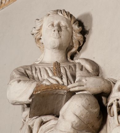 Zdjęcie nr 79: Kaplica pod wezwaniem Najświętszej Marii Panny i Wszystkich Świętych przylega do kościoła od południa, do pierwszego przęsła nawy, z którą komunikuje się za pomocą półkoliście zamkniętej arkady. Zbudowana została na planie kwadratu. Nakryto ją półsferyczną czaszą na pendentywach i zwieńczono latarnią. Wnętrze artykułowano za pomocą ślepej arkady z pilastrami i archiwoltami, ozdobionymi rzeźbioną dekoracją roślinną i kasetonami z rozetami w podłuczu. Ściany kaplicy zamyka wydatne belkowanie z fryzem i łacińską inskrypcją: "DEVS MEVS ET OMNIA / DILEXI DOMINE DECOREM DOMVS / TUAE ET LOCUM HABITATIONIS GLORAE TUAE PSAL(MUS) XXV". Na czterech pendentywach umieszczono stiukowe kartusze, z czego dwa od strony wschodniej są są puste, a dwa od strony zachodniej wypełniają herby skwadrowane: Gryf, Kotwicz, Kotwicz, Zabawa i Jastrzębiec, Nowina, Gozdawa, Pobóg. Wnętrze doświetlają trzy takie same okulusy umieszczone na każdej ze ścian. Czwarty okulus w ścianie północnej jest zaślepiony. Glify okulusów dekorowane są kasetonami z rozetami. Ściany kaplicy oraz wnętrze kopuły i latarni pokrywa polichromia figuralna. Po arkadą na ścianie wschodniej zawieszono obraz Matki Boskiej z Dzieciątkiem w bogato rzeźbionej roślinno-kwiatowej ramie zwieńczonej godłem z dwiema skrzyżowanymi laskami marszałkowskimi. Pod obrazem znajduje się nagrobek dziecięcy Jana Czuryły (zm. 1560) w formie płaskorzeźbionej, prostokątnej płyty z wyobrażeniem zmarłego. Nad płytą zlokalizowano mniejszą z inskrypcją odnoszącą się do zmarłego. Z kolei wnętrze arkady z herbem Gryf w kluczu na ścianie południowej wypełnia trójosiowy nagrobek Branickich z półokrągłym zwieńczeniem. Natomiast w arkadzie zachodniej wyobrażono scenę Zdjęcia z krzyża w formie malowidła ściennego. Wyposażenie wnętrza dopełniają dwie drewniane ławy kościelne. Ściany zewnętrzne wspierają dwie niskie przypory widoczne w narożach kaplicy. Całość zakończona jest belkowaniem z fryzem zawierającym inskrypcję: "AD LAVDEM DEI OPT(IMO) M(AXIMO) BEATEQUE GENITRICIS MARIAE VIRGINIS ET OMNIUM SANCTORU(M) HONOREM JOHANNES A RVSCZA BRANICZKI VENATOR CRACOVIEN(SIS) ET CAPITANEVS NIEPOLONICEN(SIS) - HANC CAPELLAM EX FVNDAMENTIS EREXIT ANNO D(OMI)NI 1596". Na ścianie południowej widnieje półokrągła blenda z malowanym przedstawieniem Matki Boskiej Częstochowskiej. Latarnię kaplicy wieńczy głowica z czterema maskami maszkaronów, na której wspiera się złocona kula z krzyżem.