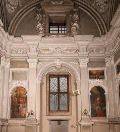 Zdjęcie nr 125: Kaplica zbudowana została na planie kwadratu i nakryta wzniesioną na pendentywach kopułą z latarnią. Przylega do kościoła od północy, do pierwszego przęsła nawy, z którą komunikuje się zamkniętym półkoliście przejściem. Wnętrze artykułowane jest w oparciu o schemat starożytnego łuku triumfalnego za pomocą osadzonych na wysokim cokole pilastrów z kompozytowymi głowicami. Pilastry podtrzymują wydatne belkowanie, ozodbione dekoracją stiukową w postaci puttów, festonów owocowych, rozet oraz kartuszy. Równocześnie pilastry ujmują półkoliste arkady, dwie niższe i większą, środkową. Niższe arkady wypełniają obrazy ze scenami z życia św. Karola Boromeusza. Ponad nimi w prostokątnych, stiukowych, obramieniach znajdują się malowane przedstawienia różnych świętych. W środkowej arkadzie ściany północnej umieszczono okazały późnobarokowy ołtarz z cudownym wizerunkiem św. Karola Boromeusza. Z kolei w arkadach wschodniej i zachodniej rozmieszczono prostokątne okna. Poniżej okna w arkadzie zachodniej znajduje się wyjście na zewnątrz kaplicy zaopatrzone w metalowe, prostokątne drzwi. Natomiast pod oknem w ścianie wschodniej zawieszono tablicę pamiątkową ku czci papieża Jana Pawła II. Arkadę wejściową do kaplicy zamyka prostokątna, brązowa krata. W jej podłuczu od wnętrza na wzór tympanonu umieszczono stiukowy kartusz z herbem Szreniawa, podtrzymywany przez dwa anioły. Ściany tarczowe podniebia przepruto czworobocznymi oknami ujętymi w stiukowe obramienia wolutowe. Na pendentywach przedstawiono w czterech stiukowych kartuszach herby: Szreniawa, Gryf i Kotwicz. Czwarty kartusz jest pusty. Czaszę kopuły wypełnia iluzjonistycznie malowana architektura podzielona na dwie strefy. Dolną artykułują pary pilastrów ujmujące okulusy oraz tralkowa balustrada, a górną gurty wyznaczające pola dla dekoracji ornamentalnej. Ściany zewnętrzne kaplicy zostały podzielone za pomocą kamiennych gzymsów i lizen na dwie trójosiowe kondygnacje, z których górna odpowiada wysokością smukłemu cokołowi mieszczącemu wejście. Zewnętrzne pola każdej elewacji dekorowane są płaskimi pasami tynku w układzie wzoru geometrycznego, zbliżonego do okuciowego. Okna i portal zostały ujęte w profilowane kamienne obramienia. Na ścianie północnej w środkowej kondygnacji pod kartuszem z herbem Szreniawa umieszczono tablicę fundacyjną z napisem: STANISLAUS COMES IN WIŚNICZ LUBOMIRSKI / PALATINUS ET GENERALIS CRACOVIEN[SIS] / SCEPUSIEN[SIS], BIALLOCERKIEVIEN[SIS] / ZATHORIEN[SIS], NIEPOLOMICIEN[SIS] E[T]C[ETER]A, E[T]C[ETER]A, CAPITANEUS / CAPELLAM HANC, / S[ANCTO] CAROLO BARRHOMAEO SUO TUTELARI PATRONO / POST RECEPTA SA[N]CTI HUIUS MERITIS TOT BENEFICIA / DICATAM / EX FUNDAMENTIS EREXIT, DONAVIT / EXORNAVIT, / ANNO D[O]MI[NI], 1640 (Stanisław hrabia na Wiśniczu Lubomirski wojewoda i starosta generalny krakowski, starosta spiski, białocerkiewski, zatorski, niepołomicki, i tak dalej, i tak dalej, tę kaplicę, poświęconą św. Karolowi Boromeuszowi, swojemu patronowi opiekuńczemu, po otrzymaniu tak wielkich łask za wstawiennictwem tego świetego, od fundamentów wzniósł, uposażył i ozdobił, roku Pańskiego 1640). Dach kaplicy oraz latarnia pokryte są blachą miedzianą.
