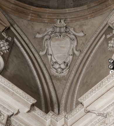 Zdjęcie nr 39: Kaplica zbudowana została na planie kwadratu i nakryta wzniesioną na pendentywach kopułą z latarnią. Przylega do kościoła od północy, do pierwszego przęsła nawy, z którą komunikuje się zamkniętym półkoliście przejściem. Wnętrze artykułowane jest w oparciu o schemat starożytnego łuku triumfalnego za pomocą osadzonych na wysokim cokole pilastrów z kompozytowymi głowicami. Pilastry podtrzymują wydatne belkowanie, ozodbione dekoracją stiukową w postaci puttów, festonów owocowych, rozet oraz kartuszy. Równocześnie pilastry ujmują półkoliste arkady, dwie niższe i większą, środkową. Niższe arkady wypełniają obrazy ze scenami z życia św. Karola Boromeusza. Ponad nimi w prostokątnych, stiukowych, obramieniach znajdują się malowane przedstawienia różnych świętych. W środkowej arkadzie ściany północnej umieszczono okazały późnobarokowy ołtarz z cudownym wizerunkiem św. Karola Boromeusza. Z kolei w arkadach wschodniej i zachodniej rozmieszczono prostokątne okna. Poniżej okna w arkadzie zachodniej znajduje się wyjście na zewnątrz kaplicy zaopatrzone w metalowe, prostokątne drzwi. Natomiast pod oknem w ścianie wschodniej zawieszono tablicę pamiątkową ku czci papieża Jana Pawła II. Arkadę wejściową do kaplicy zamyka prostokątna, brązowa krata. W jej podłuczu od wnętrza na wzór tympanonu umieszczono stiukowy kartusz z herbem Szreniawa, podtrzymywany przez dwa anioły. Ściany tarczowe podniebia przepruto czworobocznymi oknami ujętymi w stiukowe obramienia wolutowe. Na pendentywach przedstawiono w czterech stiukowych kartuszach herby: Szreniawa, Gryf i Kotwicz. Czwarty kartusz jest pusty. Czaszę kopuły wypełnia iluzjonistycznie malowana architektura podzielona na dwie strefy. Dolną artykułują pary pilastrów ujmujące okulusy oraz tralkowa balustrada, a górną gurty wyznaczające pola dla dekoracji ornamentalnej. Ściany zewnętrzne kaplicy zostały podzielone za pomocą kamiennych gzymsów i lizen na dwie trójosiowe kondygnacje, z których górna odpowiada wysokością smukłemu cokołowi mieszczącemu wejście. Zewnętrzne pola każdej elewacji dekorowane są płaskimi pasami tynku w układzie wzoru geometrycznego, zbliżonego do okuciowego. Okna i portal zostały ujęte w profilowane kamienne obramienia. Na ścianie północnej w środkowej kondygnacji pod kartuszem z herbem Szreniawa umieszczono tablicę fundacyjną z napisem: STANISLAUS COMES IN WIŚNICZ LUBOMIRSKI / PALATINUS ET GENERALIS CRACOVIEN[SIS] / SCEPUSIEN[SIS], BIALLOCERKIEVIEN[SIS] / ZATHORIEN[SIS], NIEPOLOMICIEN[SIS] E[T]C[ETER]A, E[T]C[ETER]A, CAPITANEUS / CAPELLAM HANC, / S[ANCTO] CAROLO BARRHOMAEO SUO TUTELARI PATRONO / POST RECEPTA SA[N]CTI HUIUS MERITIS TOT BENEFICIA / DICATAM / EX FUNDAMENTIS EREXIT, DONAVIT / EXORNAVIT, / ANNO D[O]MI[NI], 1640 (Stanisław hrabia na Wiśniczu Lubomirski wojewoda i starosta generalny krakowski, starosta spiski, białocerkiewski, zatorski, niepołomicki, i tak dalej, i tak dalej, tę kaplicę, poświęconą św. Karolowi Boromeuszowi, swojemu patronowi opiekuńczemu, po otrzymaniu tak wielkich łask za wstawiennictwem tego świetego, od fundamentów wzniósł, uposażył i ozdobił, roku Pańskiego 1640). Dach kaplicy oraz latarnia pokryte są blachą miedzianą.
