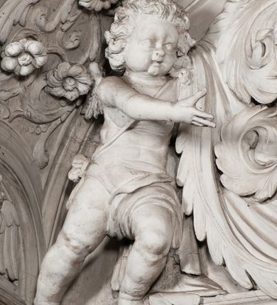 Zdjęcie nr 105: Kaplica zbudowana została na planie kwadratu i nakryta wzniesioną na pendentywach kopułą z latarnią. Przylega do kościoła od północy, do pierwszego przęsła nawy, z którą komunikuje się zamkniętym półkoliście przejściem. Wnętrze artykułowane jest w oparciu o schemat starożytnego łuku triumfalnego za pomocą osadzonych na wysokim cokole pilastrów z kompozytowymi głowicami. Pilastry podtrzymują wydatne belkowanie, ozodbione dekoracją stiukową w postaci puttów, festonów owocowych, rozet oraz kartuszy. Równocześnie pilastry ujmują półkoliste arkady, dwie niższe i większą, środkową. Niższe arkady wypełniają obrazy ze scenami z życia św. Karola Boromeusza. Ponad nimi w prostokątnych, stiukowych, obramieniach znajdują się malowane przedstawienia różnych świętych. W środkowej arkadzie ściany północnej umieszczono okazały późnobarokowy ołtarz z cudownym wizerunkiem św. Karola Boromeusza. Z kolei w arkadach wschodniej i zachodniej rozmieszczono prostokątne okna. Poniżej okna w arkadzie zachodniej znajduje się wyjście na zewnątrz kaplicy zaopatrzone w metalowe, prostokątne drzwi. Natomiast pod oknem w ścianie wschodniej zawieszono tablicę pamiątkową ku czci papieża Jana Pawła II. Arkadę wejściową do kaplicy zamyka prostokątna, brązowa krata. W jej podłuczu od wnętrza na wzór tympanonu umieszczono stiukowy kartusz z herbem Szreniawa, podtrzymywany przez dwa anioły. Ściany tarczowe podniebia przepruto czworobocznymi oknami ujętymi w stiukowe obramienia wolutowe. Na pendentywach przedstawiono w czterech stiukowych kartuszach herby: Szreniawa, Gryf i Kotwicz. Czwarty kartusz jest pusty. Czaszę kopuły wypełnia iluzjonistycznie malowana architektura podzielona na dwie strefy. Dolną artykułują pary pilastrów ujmujące okulusy oraz tralkowa balustrada, a górną gurty wyznaczające pola dla dekoracji ornamentalnej. Ściany zewnętrzne kaplicy zostały podzielone za pomocą kamiennych gzymsów i lizen na dwie trójosiowe kondygnacje, z których górna odpowiada wysokością smukłemu cokołowi mieszczącemu wejście. Zewnętrzne pola każdej elewacji dekorowane są płaskimi pasami tynku w układzie wzoru geometrycznego, zbliżonego do okuciowego. Okna i portal zostały ujęte w profilowane kamienne obramienia. Na ścianie północnej w środkowej kondygnacji pod kartuszem z herbem Szreniawa umieszczono tablicę fundacyjną z napisem: STANISLAUS COMES IN WIŚNICZ LUBOMIRSKI / PALATINUS ET GENERALIS CRACOVIEN[SIS] / SCEPUSIEN[SIS], BIALLOCERKIEVIEN[SIS] / ZATHORIEN[SIS], NIEPOLOMICIEN[SIS] E[T]C[ETER]A, E[T]C[ETER]A, CAPITANEUS / CAPELLAM HANC, / S[ANCTO] CAROLO BARRHOMAEO SUO TUTELARI PATRONO / POST RECEPTA SA[N]CTI HUIUS MERITIS TOT BENEFICIA / DICATAM / EX FUNDAMENTIS EREXIT, DONAVIT / EXORNAVIT, / ANNO D[O]MI[NI], 1640 (Stanisław hrabia na Wiśniczu Lubomirski wojewoda i starosta generalny krakowski, starosta spiski, białocerkiewski, zatorski, niepołomicki, i tak dalej, i tak dalej, tę kaplicę, poświęconą św. Karolowi Boromeuszowi, swojemu patronowi opiekuńczemu, po otrzymaniu tak wielkich łask za wstawiennictwem tego świetego, od fundamentów wzniósł, uposażył i ozdobił, roku Pańskiego 1640). Dach kaplicy oraz latarnia pokryte są blachą miedzianą.
