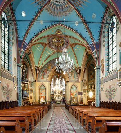 Zdjęcie nr 7: Kościół św. Michała Archanioła jest usytuowany na wysokim wzniesieniu w centrum Mszany Dolnej, na północ od głównej drogi z Raby Niżnej do Kasiny Wielkiej. Teren przykościelny jest otoczony wysokim murem posadowionym na kamiennej podmurówce oraz słupkach z nieregularnych ciosów kamienia i z żeliwnym płotem. W części północnej muru zlokalizowana jest szeroka brama, a od strony południowo-wschodniej na teren przykościelny prowadzą wysokie schody i bramka w murze. 

Kościół jest orientowany, murowany, otynkowany, jednonawowy na rzucie krzyża łacińskiego z czworoboczną wieżą w fasadzie. Wnętrze tworzy wydłużone, zamknięte pięciobocznie, dwuprzęsłowe prezbiterium, które oddziela ściana arkady tęczowej. Nawa jest szersza, czteroprzęsłowa, nakryta sklepieniem krzyżowo-żebrowym. Ramiona transeptu zwyczajowo zwane kaplicami są jednoprzęsłowe, otwarte szerokimi arkadami do nawy. Sklepienie nad skrzyżowaniem nawy z transeptem gwiaździste. Prezbiterium z nawą są połączone szeroką, ostrołukową arkadą w ścianie tęczowej. Od północy i od południa do prezbiterium przylegają dwie zakrystie na planie prostokąta, zamknięte trójbocznie. Wejście do zakrystii zaznaczone wysoką ostrołukową arkadą. Na zachodniej ścianie nawy chór muzyczny, wsparty na dwóch kolumnach, dostępny klatką schodową od nawy. 

Nawę oświetlają umieszczone w południowych i północnych ścianach prostokątne, zamknięte ostrołukowo okna, takie same znajdują się w prezbiterium; w wieży okno koliste w pierwszej kondygnacji, a w wyższych ostrołukowe wąskie okienka zamknięte żaluzjami. Wszystkie okna w nawie i prezbiterium wypełnione są witrażami lub ozdobnymi przeszkleniami. Do kościoła prowadzi główne wejście od strony zachodniej oraz dwa mniejsze w przybudówkach przy zakrystiach.

W zewnętrznej elewacji kościoła widoczny jest niewysoki kamienny cokół, otynkowany. Prezbiterium, niższe od nawy, oszkarpowane. Nawa również oszkarpowana, nakryta dachem dwuspadowym z wieżą na sygnaturkę na skrzyżowaniu nawy z transeptem. Ramiona transeptu od strony północnej i południowej, a także nawa od strony wschodniej zakończone są wysokim szczytami schodkowymi, ze ścianami ozdobionymi ostrołukowymi blendami. Na zachodnim zakończeniu nawy znacznie niższy szczyt schodkowy. Do zachodniej fasady kościoła dostawiona jest wysoka założona na planie kwadratu wieża-dzwonnica w narożach wzmocniona kamiennymi szkarpami. W dolnej kondygnacji, na osi kościoła, prostokątne wejście do kruchty zaakcentowane dwoma stopniami oraz przedsionkiem w kształcie ostrołukowej arkady, zamkniętej dodatkowo trójkątnym szczytem pokrytym blaszanym daszkiem; powyżej rozglifione koliste okno. Po lewej stronie wejścia do kościoła w płytkiej wnęce umieszczone jest popiersie księdza Józefa Stabrawy z tablicą pamiątkową. 

