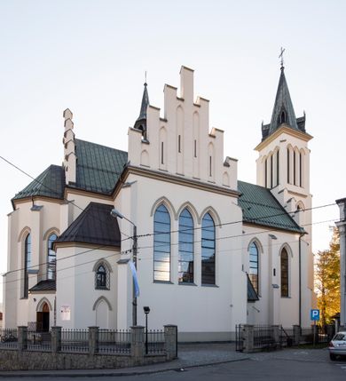 Zdjęcie nr 23: Kościół św. Michała Archanioła jest usytuowany na wysokim wzniesieniu w centrum Mszany Dolnej, na północ od głównej drogi z Raby Niżnej do Kasiny Wielkiej. Teren przykościelny jest otoczony wysokim murem posadowionym na kamiennej podmurówce oraz słupkach z nieregularnych ciosów kamienia i z żeliwnym płotem. W części północnej muru zlokalizowana jest szeroka brama, a od strony południowo-wschodniej na teren przykościelny prowadzą wysokie schody i bramka w murze. 

Kościół jest orientowany, murowany, otynkowany, jednonawowy na rzucie krzyża łacińskiego z czworoboczną wieżą w fasadzie. Wnętrze tworzy wydłużone, zamknięte pięciobocznie, dwuprzęsłowe prezbiterium, które oddziela ściana arkady tęczowej. Nawa jest szersza, czteroprzęsłowa, nakryta sklepieniem krzyżowo-żebrowym. Ramiona transeptu zwyczajowo zwane kaplicami są jednoprzęsłowe, otwarte szerokimi arkadami do nawy. Sklepienie nad skrzyżowaniem nawy z transeptem gwiaździste. Prezbiterium z nawą są połączone szeroką, ostrołukową arkadą w ścianie tęczowej. Od północy i od południa do prezbiterium przylegają dwie zakrystie na planie prostokąta, zamknięte trójbocznie. Wejście do zakrystii zaznaczone wysoką ostrołukową arkadą. Na zachodniej ścianie nawy chór muzyczny, wsparty na dwóch kolumnach, dostępny klatką schodową od nawy. 

Nawę oświetlają umieszczone w południowych i północnych ścianach prostokątne, zamknięte ostrołukowo okna, takie same znajdują się w prezbiterium; w wieży okno koliste w pierwszej kondygnacji, a w wyższych ostrołukowe wąskie okienka zamknięte żaluzjami. Wszystkie okna w nawie i prezbiterium wypełnione są witrażami lub ozdobnymi przeszkleniami. Do kościoła prowadzi główne wejście od strony zachodniej oraz dwa mniejsze w przybudówkach przy zakrystiach.

W zewnętrznej elewacji kościoła widoczny jest niewysoki kamienny cokół, otynkowany. Prezbiterium, niższe od nawy, oszkarpowane. Nawa również oszkarpowana, nakryta dachem dwuspadowym z wieżą na sygnaturkę na skrzyżowaniu nawy z transeptem. Ramiona transeptu od strony północnej i południowej, a także nawa od strony wschodniej zakończone są wysokim szczytami schodkowymi, ze ścianami ozdobionymi ostrołukowymi blendami. Na zachodnim zakończeniu nawy znacznie niższy szczyt schodkowy. Do zachodniej fasady kościoła dostawiona jest wysoka założona na planie kwadratu wieża-dzwonnica w narożach wzmocniona kamiennymi szkarpami. W dolnej kondygnacji, na osi kościoła, prostokątne wejście do kruchty zaakcentowane dwoma stopniami oraz przedsionkiem w kształcie ostrołukowej arkady, zamkniętej dodatkowo trójkątnym szczytem pokrytym blaszanym daszkiem; powyżej rozglifione koliste okno. Po lewej stronie wejścia do kościoła w płytkiej wnęce umieszczone jest popiersie księdza Józefa Stabrawy z tablicą pamiątkową. 

