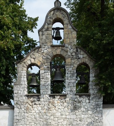 Zdjęcie nr 21: Kościół jest usytuowany w centrum wsi Rudawa, na północ od głównej drogi z Zabierzowa do Chrzanowa. Teren wokół niego jest otoczony wysokim, kamiennym murem z nieregularnych ciosów kamienia, oszkarpowanym, tynkowanym, z wyjątkiem zewnętrznej części muru na zachód od południowej bramki. W murze znajdują się trzy wejścia, od wschodu, południa i zachodu. W części wschodniej muru znajduje się trójosiowa brama wjazdowa, zwieńczona łukiem wklęsło-wypukłym, z trzema przelotami: środkowym wyższym i szerszym, zamkniętym łukiem odcinkowym i bocznymi węższymi i niższymi, zamkniętymi łukiem półkolistym (północne zamurowane). Część środkowa jest flankowana zdwojonymi pilastrami, podtrzymującymi profilowane uskokowe belkowanie z przyczółkiem o profilowanym łuku falistym, zwieńczonym równoramiennym krzyżem. W przyczółku wnęka z figurą św. Floriana. Bramki od strony zachodniej i południowej prostokątne, z przejściem zakończonym płaskim łukiem odcinkowym, z profilowanym gzymsem, zwieńczonym trójkątnym przyczółkiem. Przejścia zamykane drewnianymi ażurowymi i pomalowanymi na ciemnobrązowo jednoskrzydłowymi drzwiami. Poprzez bramkę od zachodu zejście kamiennymi schodami poprowadzonymi wzdłuż muru na dziedziniec plebański, usytuowany poniżej terenu kościelnego. 
W północno-wschodnim narożniku muru niewielka murowana i tynkowana kostnica na planie kwadratu, nakryta dachem namiotowym, łamanym, zakończonym ośmioboczną ślepą latarnią.

Po stronie południowej, poniżej placu kościelnego, do muru przylega murowana, tynkowana, prostokątna i dwukondygnacyjna „zegarowa” wieża bramna nakryta namiotowym dachem z wysoką drewnianą ośmioboczną latarnią o cebulastym hełmie. W wieży znajduje się przejazd wiodący na dziedziniec plebański, z sienią otwartą na przestrzał w dolnej kondygnacji i z lamusem dostępnym od strony placu kościelnego w górnej. 

W południowej części muru, w pobliżu południowo-wschodniego narożnika placu kościelnego, nadbudowana kamienna dzwonnica parawanowa z zawieszonymi czterema dzwonami.  

We wschodniej części placu kościelnego pomiędzy bramką wschodnią a kostnicą znajduje się kamienna ambona, o ośmiobocznej podstawie przechodzącej w szerszy, również ośmioboczny korpus, zakończony kamiennym parapetem, z kamiennymi schodami prowadzącymi na ambonę od strony wschodniej. 

Kościół jest orientowany, prawie w całości zbudowany z cegły, otynkowany z wyjątkiem prezbiterium. Wnętrze kościoła tworzy niewielkie, prostokątne, jednoprzęsłowe prezbiterium zakończone prostą ścianą i nakryte pozornym sklepieniem krzyżowo-żebrowym. Nawa jest szersza, prawie kwadratowa, nakryta drewnianym stropem. Prezbiterium z nawą są połączone szeroką, ostrołukową arkadą w ścianie tęczowej. Od północy do prezbiterium przylega założona na planie prostokąta dwuprzęsłowa zakrystia, nakryta sklepieniem krzyżowym. Wejście do zakrystii zaznaczone gotyckim, kamiennym, sfazowanym portalem zamkniętym łukiem ostrym. Od zachodu do zakrystii przylega niewielkie pomieszczenie gospodarcze, do którego z zakrystii prowadzą ostrołukowe drzwi. Zakrystia oświetlona ostrołukowym oknem w ścianie wschodniej, wypełnionym witrażem z tafelek w kształcie sześciokąta foremnego, ze szkła surowego, tzw. katedralnego. 

Od południa do nawy przylega kaplica o formach renesansowych, dwukondygnacyjna, założona na planie kwadratu. W dolnej kondygnacji sklepiona krzyżowo-żebrowo kruchta otwarta do nawy szeroką, zamkniętą półkoliście arkadą.

Ponad kruchtą kaplica św. Kazimierza, nakryta wspartą na pendentywach kopułą z latarnią. Z kruchty do kaplicy prowadzą kręte kamienne schody umieszczone od zachodu w półkolistej wieżyczce. Prostokątne wejście z krypty na klatkę schodową ujęte kamiennym profilowanym portalem. Kaplica otwarta do nawy szeroką, zamkniętą półkoliście arkadą, o kształcie i wymiarach analogicznych do arkady znajdującej się poniżej. Kaplicę, prócz latarni, oświetla prostokątne okno w ścianie południowej, wypełnione witrażem z tafelek w kształcie gomółek, ze szkła surowego, tzw. katedralnego. Na zachodniej ścianie nawy chór muzyczny, dostępny klatką schodową ukrytą w zewnętrznym aneksie przylegającym do zachodniej elewacji nawy i południowej elewacji wieży-dzwonnicy. 

Nawę i prezbiterium oświetlają umieszczone w południowych ścianach prostokątne, rozglifione okna: jedno w prezbiterium, dwa w nawie. Wszystkie wypełnione witrażami z tafelek w kształcie gomółek, ze szkła surowego, tzw. katedralnego. 

Do kościoła prowadzą dwa wejścia: poprzez arkadę z kruchty południowej oraz szerokie wejście główne prostokątne, zamknięte łukiem odcinkowym, prowadzące do kościoła z obszernej kruchty od strony zachodniej, znajdującej się w murowanym przyziemiu wieży - dzwonnicy. Kruchta, założona na planie kwadratu i nakryta murowanym stropem, doświetlona jest dwoma prostokątnymi oknami umieszczonymi naprzeciw siebie w ścianach północnej i południowej.
 
W zewnętrznej elewacji kościoła widoczny niewysoki kamienny cokół wykonany z nieregularnych ciosów kamienia. Prezbiterium, niższe od nawy, murowane z cegły w układzie wedyjskim, z domieszką układu polskiego. Wschodnie naroża prezbiterium zaakcentowane płaskimi lizenami. We wschodniej ścianie widoczny zarys zamurowanego wydłużonego okna zamkniętego lekko zaostrzonym łukiem, w trójkątnym szczycie znajduje się niewielkie wąskie okienko zakończone łukiem półkolistym. Południowa ściana prezbiterium ozdobiona fryzem z cegieł. Do ściany północnej prezbiterium przylega zakrystia, oszkarpowana, nakryta dachem pulpitowym, z dobudowanym od niej niewielkim aneksem, nakrytym takim samym zadaszeniem. Do wschodniej ściany prezbiterium przylega ogrójec nakryty dachem namiotowym z cebulastym zwieńczeniem, wspartym na sześciu smukłych, profilowanych drewnianych słupach z mieczami, pomiędzy którymi od północy i południa ażurowa drewniana balustrada. 

Nawa oszkarpowana w narożnikach. Elewacje bez podziałów architektonicznych. Od strony południowej do nawy dobudowana dwukondygnacyjna kaplica nakryta kopułą z latarnią, podzielona na dwie kondygnacje. W dolnej kondygnacji od południa wejście do kruchty zaznaczone kamiennym portalem o sfazowanych węgarach i lekko zaostrzonym łuku. Wejście zamykają drewniane dwuskrzydłowe drzwi ozdobione kratownicą z żelaznych listew. Od zachodu do kaplicy przylega półokrągła wieżyczka nakryta daszkiem stożkowym. 

Do zachodniej fasady kościoła dostawiona niska, założona na planie kwadratu trójkondygnacyjna wieża-dzwonnica: w dolnej części murowana, w narożach wzmocniona kamiennymi szkarpami, w górnej drewniana konstrukcji słupowo-ramowej z nadwieszoną izbicą i nakryta dachem półszczytowym. W dolnej, murowanej kondygnacji, na osi kościoła, prostokątne wejście do kruchty zaakcentowane przedsionkiem w kształcie ostrołukowej arkady i czterostopniowymi schodami. Przedsionek nakryty dachem dwuspadowym. Do zachodniej elewacji nawy i południowej elewacji dzwonnicy przylega niewielki, wysoki drewniany aneks, nakryty dachem pulpitowym, mieszczący klatkę schodową prowadzącą na górną kondygnację dzwonnicy i na chór muzyczny w nawie kościoła. Prostokątne wejście w południowej ścianie aneksu, do którego prowadzą pięciostopniowe proste schody. Ponad nimi, na wysokości drugiej kondygnacji dzwonnicy, niewielkie kwadratowe okno. 

Prezbiterium i nawa przykryte stromymi dachami dwuspadowymi, zamkniętymi od wschodu i zachodu szczytami sterczynowymi. Wieżyczka na sygnaturkę ośmioboczna, w dolnej części barokowa, w górnej części nowsza.