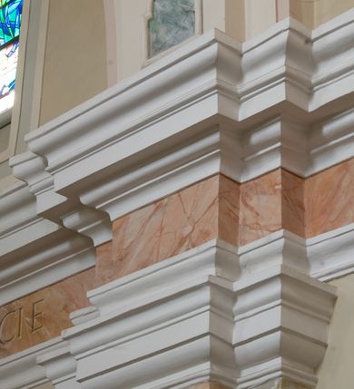 Zdjęcie nr 9: Kościół murowany, orientowany, jednonawowy (z dodatkową przestrzenią od południa powstałą w wyniku połączenia trzech kaplic), z półkoliście zamkniętym prezbiterium, z prostokątną zakrystią od północy, z kruchtą na osi nawy głównej oraz drugą od północy; między zakrystią a kruchtą północną babiniec. 
Nawa szersza od prezbiterium, prostokątna, trójprzęsłowa, ze sklepieniem kolebkowym z lunetami na gurtach. Od zachodu chór muzyczny wsparty na kolumnach. Ściany nawy podzielone zdwojonymi pilastrami, między którymi nisze arkadowe, od południa półokrągłe arkady łączące nawę główną z nawą boczną. Partię ścian od sklepienia oddziela pełne belkowanie wyłamane na osi pilastrów, które jest kontynuowane w przekrytym sklepieniem kolebkowym z lunetami prezbiterium.  
W partii przyziemia oraz sklepienia prostokątne okna w rozglifionych obramieniach zamkniętych łukiem odcinkowym, na osi prezbiterium owalne. Od zachodu oraz od południa drzwi zamknięte łukiem odcinkowym. 
Fasada trójosiowa, dwukondygnacyjna, zwieńczona trójkątnym przyczółkiem, poprzedzona jednokondygnacyjną kruchtą, do której wchodzi się po sześciostopniowych schodach. Osie rozdzielone są pojedynczymi lub zdwojonymi pilastrami, kondygnacje dzieli bogato profilowane belkowanie. W kruchcie drzwi o wykroju prostokąta zamknięte łukiem odcinkowym, okna w osiach bocznych o identycznym jak drzwi wykroju; okulus w szczycie. W osi środkowej drugiej kondygnacji fasady okno prostokątne, zamknięte łukiem odcinkowym, a u szczytu okulus. 
Na elewacjach kontynuowany jest gzyms oddzielający drugą kondygnację i partię dachu, pionowe podziały utworzone zostały przez lizeny. 
Nawa główna oraz kruchty nakryte dachami dwuspadowymi, część nawy bocznej, zakrystia oraz babiniec jednospadowymi, druga część nawy bocznej trójspadowym, zakrystia dwuspadowym zamkniętym półkoliście. Dwie wieżyczki na sygnaturki: jedna nad nawą główną, druga, mniejsza nad prezbiterium. Obie przeprute arkadami, zwieńczone kopułami z kulą i krzyżem. 
Do najważniejszych elementów wyposażenia należą: ołtarz główny późnobarokowy z obrazem Przemienienia Pańskiego przywieziony z Rzymu w 1723 roku, dwa regencyjne ołtarze boczne z barokowymi obrazami Matki Boskiej z Dzieciątkiem oraz św. Katarzyny, oba ozdobione sukienkami oraz obraz z przedstawieniem św. Józefa, pochodzący z trzeciego ołtarza wisi teraz na ścianie nawy głównej. 
