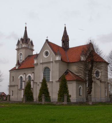 Zdjęcie nr 7: Kościół na planie krzyża łacińskiego, jednonawowy, pięcioprzęsłowy, z transeptem i jednoprzęsłowym prezbiterium zakończonym wielobocznie. Ramiona transeptu jednoprzęsłowe, o wysokości nawy, zamknięte prostymi ścianami. W narożnikach pomiędzy prezbiterium i ramionami transeptu dwa prostokątne aneksy mieszczące zakrystię i skarbiec. Prezbiterium i ramiona transeptu oddzielone od nawy wydatnymi półfilarami przechodzącymi bezpośrednio w gurty sklepienne. Prezbiterium od absydy oddziela arkada tęczowa wsparta na dostawionych do węgarów kolumnach kompozytowych. Sklepienie nad skrzyżowaniem naw krzyżowe, nad pozostałymi przęsłami nawy kolebkowe o przekroju koszowym, nad ramionami transeptu krzyżowe (ostrołukowe), w absydzie ćwierćsferyczne z lunetami. Otwory okienne prostokątne, zamknięte półkoliście, rozglifione do wewnątrz; trzy pary w nawie, dwa na ścianach zamykających ramiona transeptu. Ponad oknami w transepcie dodatkowo po jednym okrągłym oknie wypełnionym rozetą. W prezbiterium okna w kształcie wydłużonego prostokąta o smukłych proporcjach zamkniętego półkoliście, pomiędzy nimi para regularnie rozmieszczonych okien owalnych.  W zachodnim przęśle nawy murowany trójprzęsłowy chór muzyczny wsparty na parze ośmiobocznych filarów z cokołami, a pod ścianami na parze półfilarów. Balustrada o prostej dekoracji płycinowej. Podniebie chóru podzielone belkami na trzy kasetony, pośrodku których kwadratowe płyciny. Fasada kościoła dwukondygnacyjna, trójosiowa przechodząca w czworoboczną wieżę. Ściany rozczłonkowane lizenami, kondygnacje oddzielone profilowanym gzymsem. W części środkowej wejście zamknięte łukiem półkolistym, z dwuspadowym drewnianym daszkiem, wyżej prostokątne okno zamknięte półkoliście. W polach bocznych mniejsze, prostokątne okna zamknięte półkoliście. Wieża o narożach ujętych lizenami, podtrzymującymi gzyms, nakryta ozdobnym zwieńczeniem z czterema wieżyczkami w narożach, pomiędzy którymi trójkątne szczyciki nad oknami i ostrosłupowy hełm zakończony krzyżem. Ściany boczne nawy i transeptu ujęte uskokowymi przyporami. Ściany zamykające ramiona transeptu podzielone na dwie strefy, z których dolna ujęta lizenami, górna wypełniona oknem w ozdobnym obramieniu. Dachy dwuspadowe, kryte dachówką. Na skrzyżowaniu naw wieloboczna, drewniana wieżyczka na sygnaturkę nakryta ostrosłupowym hełmem pokrytym blachą.

