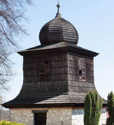 Zdjęcie nr 6: Kościół orientowany, murowany, jednonawowy z węższym prezbiterium zakończonym półkolistą absydą. Przy prezbiterium od północy znajduje się zakrystia, od południa kwadratowa kaplica św. Anny, a przy nawie od południa kruchta. Wnętrze kościoła nakryte jest nowym stropem, natomiast w kaplicy znajduje się sklepienie krzyżowo-żebrowe. Fasada zachodnia ujęta jest na narożnikach skośnymi szkarpami i zwieńczona schodkowym szczytem, podobnie zwieńczona jest kruchta południowa. Portal zachodni kamienny, z belkowaniem wspartym na dwóch liściastych konsolach ponad którymi edikula z płaskorzeźbionym krucyfiksem i klęczącymi postaciami męskimi. Na belkowaniu znajdują się dwa kartusze z herbami: po lewej herb Bończa, a nad nim litery „I” oraz „T”, a na prawo herb Szreniawa i litery „B” i „T”. Portal kruchty południowej jest również kamienny, podobny do zachodniego z inskrypcją: „IN LAVDEM ET GL[ORI]AM DEI O[MN]IP[OTENTIS] HO[NO]RE[M] / B(EATE) M(ARIAE) S(ANCTAE) V(IRGINIS) S(ANCTUS) AEGIDY ET OM(NIUM) SS. FIR. REGNÃTE [TERTIO] SIGISM[UN]DO / REGE POL[ONIAE] Z[?] HEMO[?] EP[ISCOP]O CRAC(OVIENSIS) BERN[AR]DO MACIEIOWSKI / NOVIT[ER] CAR[DINA]LI CRA[COVIENSE] DEI FACTO INTERI[M] PLEBA[N]O R[E]V[EREN]DO SEB(ASTIANO) / NAGRODIO A I SYRADIA PHI[LOSOPHI]AE DOCTORE COLLEG[I]A [MA]IORE / S. T(HEOLOGIAE) PVBLICO PROFES(SORE) PRAEP[OSI]TO S(ANCTA) AN(NAE) CRAC[OVIAE] DECIMARVM / ET FVNDI ECCL(ESIA)E HVIVS P[OST] IVRIS STREPITV(M) RESTITV / TORE ANNO OCTAVO PLEBANAT[U]S SVI. TEMPLVM HO(C) / [ dwa wiersze skute] DE&#039; / NOWO AEDIFICATVM. ET. CONSTRVCTVM. ADIVTORIO / QVORVNDÃ ANNO D[OMINI] MDCIIII MENSE SEPTEMB[RE]”. Od południa świątyni umieszczone są trzy otwory okienne w kształcie stojących prostokątów, zamkniętych łukiem półkolistym, a w prezbiterium dwa małe okrągłe okna. Kościół nakryty jest dwoma dwuspadowymi dachami, nad prezbiterium nieco niższym, nad nawą zwieńczonym wąską i wysoką sygnaturką na dzwon. Wewnątrz świątyni na skrzyżowaniu nawy i prezbiterium umocowana jest drewniana belka tęczowa z ustawionym na niej krucyfiksem i figurami Matki Boskiej i św. Jana Ewangelisty. Chór zachodni drewniany, na planie prostokąta, pośrodku półkoliście zamknięty, wsparty na sześciu filarach, od północnego zachodu z obudowaną boazerią klatką schodową. 