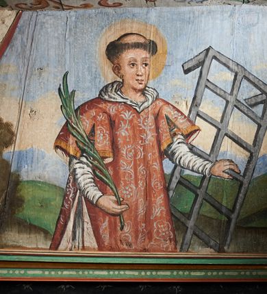 Zdjęcie nr 5: Polichromia ścienna nawy pokrywa wszystkie ściany oraz strop tej części świątyni. Polichromia figuralno-ornamentalna. W łuku tęczowym fryz podstropowy, wypełniony ornamentem w formie schematycznej, stylizowanej wici roślinnej, ujętej na krańcach uskrzydlonymi główkami anielskimi, umieszczonymi w medalionach. Poniżej fryzu, po lewej herb cesarski, ujęty w wieniec laurowy, w tle pejzaż; po przeciwnej stronie, zwieńczony insygniami biskupimi, herb biskupa Jerzego Lippay de Zongor – dwa lwy, ustawione antytetycznie przy ukoronowanej kolumnie.

Na północnej ścianie nawy do wysokości jednej trzeciej ściany pas kwater z wizerunkami świętych, ujętymi w obramienia, utworzone z ornamentu w formie silnie stylizowanej wici roślinnej. Pola pomiędzy kwaterami wypełnione schematycznym ornamentem geometryczno-figuralnym, złożonym ze skręconej wici roślinnej oraz główek anielskich. Od strony prezbiterium kolejno przedstawienia opatrzone następującymi podpisami:
„S(NCTVS) ADREAS ZOREARBUS EREMITA NITRAE / ET TRENCHINII  27 XIV LY ANNO 1609”;
„B. MATHEAI ESCANDELI NATUS BUDAE MARTIRIO AFFE/CTUS in Sinis quo infide infidelum convertendorum causa penefravit”;
„B. SADOCH ORD. PRAED. A. S. DOMINICO in UNGARIAM/ MISSUS EGREGIE LABORAVIT MARTYRIO  affectus 1260. 3. Iunii”;
„S(ANCTVS) COLOMANUS MS. MARGARITAE REGINAE SCOTIAE UNGARA/ MATRE NATAE FILIUS SUSPENSUS STOKARAVIAE COLIT 13 oct.”;
„S(ANCTVS) CAPISTRANI ORD. S. FRAC. TURCAS BELRADO FUGAVIT/ UNG. Ufilissim[us] obit 1455 23 Od. Viilaci in Ung. Sepult[us].”;
„S(ANCTVS) PETRUS THOMASIUS CARMELITA AT LUDOVICUM/ UNG. REGEM NUNTI[US] APOSTOL. De pace cum Venetis egit obit 29 9 1367”.

Kontynuacja przedstawień na ścianie zachodniej:
„B. IACOBUS PICENUS ORD. S. FRANC. S. CAPISTRANI IN UNG./ COAPOSTOL[US] MULTOS AD CHRISTI FIDEM CONVERTIT”;
„S(ANCTVS) IOANNES NEPOMUCN.”.

W górnej partii ściany północnej scena wielofiguralna: Św. Jan Chrzciciel nauczający w otoczeniu tłumu. W tle pejzaż z drzewami i  zarysowanym na najdalszym planie masywem górskim. Ponad przedstawieniem napis: „VENIT IN OMNEM REGIONEM PRAEDICANS BAPTISMUM POENITENITIAE LUCAE 3.”. Do sceny kazania św Jana Chrzciciela przylega środkowy rząd wizerunków świętych. Cztery pierwsze przedstawienia znajdują się na ścianie północnej i biegną w kierunku chóru muzycznego:
„B. BERTHODEUS (…) 17 DECE”;
„B. IOANNES DOMINICI ORD. PRAED. EP. Et. CARDIN ad. SIGISMUN. UN. BEC. NUNT. APOTOLIC. BUDAE obiit (…) 1418” [w lewym górnym rogu odnotowane białą farbą informacje o kolejnych konserwacjach polichromii];
„B. ANTONIUS UNGARUS ORD. FRANC. FULGINII/IN OBSEQUIO INFIRMORUM ob. 1398. 13 May.”;
„B. MATHAEUS ESCANDELI NATUS BUDA MARTIRIS AFFECTUS IN SINIS QUO INFIDELIUM…”.

Nad chórem muzycznym, na ścianie zachodniej znajdują się kolejne cztery wizerunki z tego cyklu:
„B. MURITIUS CSAKY ORD. PRAED AMORE IN DEIPURAM MIRACU/LIS CLARUS obiit laurmi 1336 20. Mar. [.]oii Ferr.”;
„B. MAURUS EX MANASTETRIO S. MARTINI /ORD. S. BENED. EPISC. QUINQUE ECCLESIENS in UNGARIA”;
„S(ANCTVS) BENEDICTUS MAR. EREMITA PROPE TRENCHINIUM/IN VASUM MERSUS COLITUR IM aii”;
„B. EUSEBIUS CANONICO STRIGOMI PRIMUS/PROVINCIALIS ORA: S. PAULI primi Erem: obit 1270. 20. Ian.”.

Ostatnie dwa wizerunki na ścianie południowej nad chórem muzycznym, kolejno od strony ściany tęczowej:
„S(ANCTVS) ASTRICQ ARCHIEN. COLOCENS. IN UNGARIA ORD./ s. BENEDICTI OBIIT. AN. 1034. 12 Novembris”;
„S(ANCTVS) PAULUS UNGARUS PRIMUS ORD. PRAED./ UNGARIA PROVINCIALIS MARTIRIO affectis”.

Na podniebiu zaskrzynienia kontynuacja cyklu hagiograficznego. Od łuku tęczowego, wizerunki umieszczone są między elementami ornamentacyjnym, opatrzone następującymi podpisami:
„B. GISELA S. STEPH. R. / U. CONIUX Ob. 1036”;
„S(ANCTVS) ESABETH ANDR. U. FI/LIA DUCISS THURINN ob. 1226”;
„B. GERTRUDIS V. FILIA/ S. ELISABETHAE THURING”;
„B. ELISABETH HELVETA AN/ DR III R.U. FILIA ob. 1338 6 mai”;
„B. HELENA V. ORD. PRAEDIC. OB. BUD. AN. 1720 9 nov.”;
„S(ANCTVS) MARGHARITA REGINA SCOTIAE NATA IN UNGARIA TEMORAE S. SALAMONIS”;
„B. ELISABETHU. Ord. Praed S. STEPHANI UNG. REGIS. FILIA OBIIT CIV. Anno 1285 6 martii”;
„S(ANCTA) URSULA CUM 11 000 VIRGINUM AB ATTILA INTERFECTA 1383 21 Oct.”.

Na podniebiu zaskrzynienia nad ścianą południową kontynuacja cyklu, od tęczy:
„B. MARGARITA FILIA BELAE 4 R. V. Ob. 1273. 28 Ian.”; 
„B. CUNEGUNDUDIS V. BELAE IV REG FILIA Ob. 1292. 24. 1.”.

Na ścianie południowej w dolnym pasie malowideł od strony tęczy scena figuralna z przedstawieniem św. Anny nauczającej Marię, a następnie scena piekła z przedstawieniem męki grzeszników w wypełnionej płomieniami paszczy Lewiatana. W górnej partii scena przedstawiająca pogrzeb Jana Chrzciciela. Przestrzenie wokół tego malowidła i okien szczelnie wypełnione ornamentem w formie schematycznej wici roślinnej. Drzwi pokryte dekoracją ornamentalną analogiczną do tej w przestrzeniach między obrazami w dolnym rzędzie cyklu świętych na ścianie północnej. Fryz przystropowy w całości dekorowany analogicznie jak w łuku tęczowym. 

Na stropie kontynuacja cyklu ze scenami z życia Jana Chrzciciela, rozpoczynającego się w prezbiterium. Dwa obrazy w formie prostokątów, ujęte w malowane ramy, utworzone z ornamentu złożonego z wici roślinnej i stylizowanych rozetek. Pierwsza od tęczy wielopostaciowa scena narodzin Jana Chrzciciela, w górnej partii opatrzona napisem: „QUIS PUTAS PUER ISTE ERITE IOANNES EST NOMEN EIUS LUCAE 1.”. Bliżej chóru przedstawienie Jana Chrzciciela, nauczającego na puszczy, opatrzona podpisem: „ERAT IN DESERTIS USQUE IN DIEM OSTENSIONIS SUAE LUCAE 1.”. Obrazy ujęte w iluzjonistycznie malowane kasetony z rozetami w środku. Podziały kasetonowe zaznaczone listewkami, dekorowanymi rozetkami. Pod amboną niewielkich rozmiarów malowidło, przedstawiające siedem postaci pokutujących w czyśćcu i anioła. Scena zwieńczona monogramem IHS.
