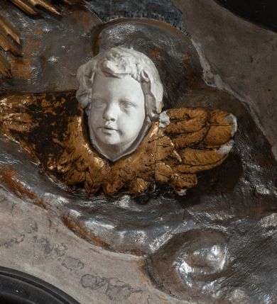 Zdjęcie nr 11: Nastawa ołtarza jest stiukowa, architektoniczna, jednoosiowa, jednokondygnacyjna, o wklęsłym licu, ze zwieńczeniem oraz osadzona na wysokim cokole. Ołtarz jest drewniany, sarkofagowy z drewnianą, silnie wysuniętą, drewnianą mensą. Retabulum ujęte jest parą zdwojonych pilastrów o trzonach dekorowanych konsolkami i kampanulami na froncie, dźwigających przerwane belkowanie. W polu środkowym umieszczono obraz św. Franciszka ujęty profilowaną ramą w formie stojącego prostokąta zamkniętego łukiem odcinkowym, nadwieszonym z uskokiem i uszakami po bokach, wklęsłego u spodu. Poniżej obrazu znajduje się płycina ujęta spływami wolutowymi, zamknięta fragmentem gzymsu w formie łuku odcinkowego. W jej polu jest kartusz o fantazyjnym wykroju. Zwieńczenie ujęto parą spływów wolutowych i zamknięto fragmentem wklęsło-wypukłego gzymsu, na którym jest krzyż na kuli. Na końcach spływów wolutowych znajduje się para siedzących putt.  
Pole zwieńczenia wypełniają płaskorzeźbione obłoki z uskrzydlonymi główkami anielskimi oraz ukazana na ich tle promienista gloria, po środku której znajduje się krzyż, kotwica, serce i wieniec laurowy (symbole Wiary, Nadziei i Miłości). Struktura retabulum jest marmoryzowana w kolorze szaro-brązowym i ciemnoszarym, ze złoconymi i srebrzonymi detalami.