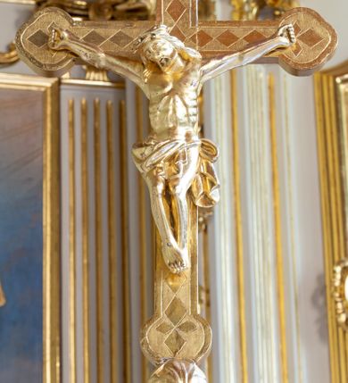 Zdjęcie nr 24: Nastawa ołtarzowa architektoniczna, trójosiowa, jednokondygnacyjna ze zwieńczeniem i bramkami. Ołtarz drewniany, prostopadłościenny; antepedium haftowane. Tabernakulum metalowe, fakturowane, w formie zbliżonej do prostopadłościennej skrzynki, ustawione na niskim cokole, o wypukłej ściance frontowej, flankowane parą kolumn o kompozytowych kapitelach. Drzwiczki w kształcie stojącego prostokąta, zamkniętego łukiem nadwieszonym; w polu kielich z hostią, a po bokach winna winorośl i kłosy zbóż. Powyżej jest tron wystawienia o fantazyjnym kształcie, ujęty po bokach wolutami, na których usadzone są dwa putta. W polu maska lunarna, otoczona promienistą glorią, a w zwieńczeniu muszla palmetowa. Nastawa ustawiona jest na wysokim, zdwojonym cokole, flankowana dwiema parami zdwojonych pilastrów, ustawionych ukośnie. Bramki w kształcie stojących prostokątów, zamkniętych półkoliście, w profilowanej obudowie zwieńczonej wolutowo. Drzwiczki dekorowane są malowanym bukietem kwiatów w wazonie. Kondygnacja o delikatnie wklęsłym przebiegu, ujęta dwiema parami zdwojonych, kanelowanych pilastrów, z których wewnętrzne ustawione są pod kątem. Podpory dźwigają pełne belkowanie, wyłamane nad osiami. Na linii wewnętrznych podpór ustawione są dwa cokoły, na których osadzono dwie główki aniołków, a na linii skrajnych podpór wolutowe przyczółki; z kolei pomiędzy nimi znajdują się fantazyjne woluty. W polu środkowym w ramie o kształcie stojącego prostokąta, zamkniętego łukiem wklęsło-wypukłym z uskokami umieszczony jest obraz Wniebowzięcia Najświętszej Marii Panny, a na zasuwie obraz św. Marcina oraz płótno przedstawiające Chrystusa Ukrzyżowanego. W osiach bocznych obrazy: po lewej św. Szczepan, a po prawej św. Wawrzyniec. Przed skrajnymi podporami ustawione są figury: po lewej św. Piotra, a po prawej św. Pawła. Nad polem głównym zawieszona jest gołębica Ducha Świętego na tle srebrzonych obłoków i promienistej glorii. Zwieńczenie w formie zbliżonej do leżącego prostokąta ujętego spływami wolutowymi, zamknięte profilowanym gzymsem i rocaille’ami. W polu obraz św. Marcina. Struktura polichromowana w kolorze jasnobeżowym, ornamentyka złocona, detale srebrzone.



