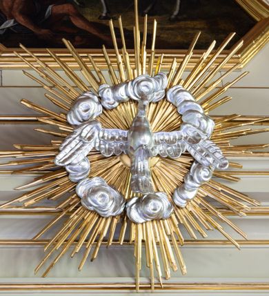 Zdjęcie nr 10: Nastawa ołtarzowa architektoniczna, trójosiowa, jednokondygnacyjna ze zwieńczeniem i bramkami. Ołtarz drewniany, prostopadłościenny; antepedium haftowane. Tabernakulum metalowe, fakturowane, w formie zbliżonej do prostopadłościennej skrzynki, ustawione na niskim cokole, o wypukłej ściance frontowej, flankowane parą kolumn o kompozytowych kapitelach. Drzwiczki w kształcie stojącego prostokąta, zamkniętego łukiem nadwieszonym; w polu kielich z hostią, a po bokach winna winorośl i kłosy zbóż. Powyżej jest tron wystawienia o fantazyjnym kształcie, ujęty po bokach wolutami, na których usadzone są dwa putta. W polu maska lunarna, otoczona promienistą glorią, a w zwieńczeniu muszla palmetowa. Nastawa ustawiona jest na wysokim, zdwojonym cokole, flankowana dwiema parami zdwojonych pilastrów, ustawionych ukośnie. Bramki w kształcie stojących prostokątów, zamkniętych półkoliście, w profilowanej obudowie zwieńczonej wolutowo. Drzwiczki dekorowane są malowanym bukietem kwiatów w wazonie. Kondygnacja o delikatnie wklęsłym przebiegu, ujęta dwiema parami zdwojonych, kanelowanych pilastrów, z których wewnętrzne ustawione są pod kątem. Podpory dźwigają pełne belkowanie, wyłamane nad osiami. Na linii wewnętrznych podpór ustawione są dwa cokoły, na których osadzono dwie główki aniołków, a na linii skrajnych podpór wolutowe przyczółki; z kolei pomiędzy nimi znajdują się fantazyjne woluty. W polu środkowym w ramie o kształcie stojącego prostokąta, zamkniętego łukiem wklęsło-wypukłym z uskokami umieszczony jest obraz Wniebowzięcia Najświętszej Marii Panny, a na zasuwie obraz św. Marcina oraz płótno przedstawiające Chrystusa Ukrzyżowanego. W osiach bocznych obrazy: po lewej św. Szczepan, a po prawej św. Wawrzyniec. Przed skrajnymi podporami ustawione są figury: po lewej św. Piotra, a po prawej św. Pawła. Nad polem głównym zawieszona jest gołębica Ducha Świętego na tle srebrzonych obłoków i promienistej glorii. Zwieńczenie w formie zbliżonej do leżącego prostokąta ujętego spływami wolutowymi, zamknięte profilowanym gzymsem i rocaille’ami. W polu obraz św. Marcina. Struktura polichromowana w kolorze jasnobeżowym, ornamentyka złocona, detale srebrzone.



