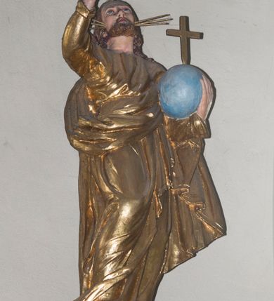 Zdjęcie nr 3: Ambona wisząca, przyścienna, z wejściem od prawej strony w postaci jednobiegowych schodów z balustradą. Kosz na planie koła otoczony kolumnami korynckimi posadowionymi na cokołach i podtrzymującymi belkowanie wyłamane na ich linii. Podwieszenie w formie stożka zakończonego dużą szyszką, dekorowanego plakietami skomponowanymi z elementów floralnych oraz  podwieszonymi szyszkami. Ścianki dekorowane malowanymi przedstawieniami  czterech ewangelistów. 
Baldachim powtarza pomniejszony plan kosza; dekorowany szyszkami, w podniebieniu lampa w kształcie szyszki. W jego zwieńczeniu umieszczono figurą Chrystusa Zbawiciela Świata (Salvator Mundi) na dwustopniowym cokole. Chrystus stoi w kontrapoście, z prawą nogą ugiętą w kolanie i wspartą na kamieniu. Lewą ręką podtrzymuje kulę ziemską zwieńczoną krzyżem, prawą unosi do góry, czyniąc gest błogosławieństwa. Spogląda do góry, ma ciemną brodę i falowane włosy spływające na ramiona i plecy. Z trzech stron głowy odchodzą wiązki promieni. Chrystus ubrany jest w długą, złotą suknię oraz tego samego koloru płaszcz owinięty wokół prawego biodra i przerzucony przez lewą rękę. 