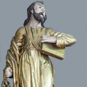 Zdjęcie nr 1: Rzeźba pełna, ustawiona na niewielkim cokole. Figura ukazana w całej postaci, zwrócona frontalnie, w delikatnym kontrapoście. Głowa skierowana lekko w lewo, uniesiona; twarz owalna, szczupła, okolona gęstym zarostem, wzrok zwrócony w górę. Włosy półdługie, kręcone, opadające na plecy. W prawej, opuszczonej wzdłuż ciała ręce święty trzyma klucze, lewą przytrzymuje zamkniętą księgę. Apostoł jest ubrany w suknię sięgającą ziemi, przewiązaną w talii; obficie drapowana w miękkie, drobne fałdki tkanina podkreśla układ ciała. Płaszcz przerzucony przez prawe przedramię opada na plecy. Polichromia naturalistyczna w odsłoniętych partiach ciała, szaty i atrybuty złocone.