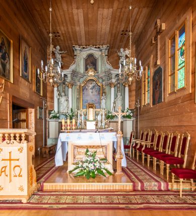 Zdjęcie nr 5: Nastawa architektoniczna, jednokondygnacyjna ze zwieńczeniem i bramkami; ustawiona na jednostopniowej podstawie. Ołtarz drewniany, prostopadłościenny, obity boazerią, mensa drewniana z kamiennym portatylem. Tabernakulum w formie drewnianej skrzynki na dwustrefowym cokole zryzalitowanym bo bokach, o lekko wklęsłej linii. Ścianka frontowa obita fakturowaną blachą; drzwiczki w formie kwadratu z aplikowanym krzyżem oraz literami: Α i Ω. Tron wystawienia w formie baldachimu podtrzymywanego przez parę skręconych kolumn oraz ścianką tylną zwieńczoną konchą; dekorowane wolutami utworzonymi z akantu i karbowanej wstęgi. W partii cokołu przejścia, flankowane skrajnie filarami, zakończonymi wyłamanym gzymsem zamykającym prześwity. 

Pole środkowe flankują dwie pary opilastrowanych filarów oraz dwie pary kolumn ustawionych pod kątem, dźwigających pełne belkowanie wyłamane na ich osi i przerwane nad polem środkowym oraz przerwany wolutowy przyczółek. W polu środkowym płytka nisza w formie stojącego prostokąta zamkniętego łukiem wklęsło-wypukłym z uskokami z obrazem Przemienienie Pańskie, ujęta profilowaną ramą. Powyżej kartusz z napisem: „Hic est Filius / meus dilectus, in quo / mihi complacui / S(ant) Joan”. Pomiędzy kolumnami figury św. Piotra po lewej stronie i św. Pawła po prawej stronie. 

Zwieńczenie w formie stojącego prostokąta ujętego pilastrami, zamkniętego gzymsem w kształcie łuku kotarowego; po bokach ujęte spływami wolutowymi. W polu środkowym obraz św. Antoniego Padewskiego, umieszczony w ramie w kształcie stojącego prostokąta zamkniętego łukiem wklęsło-wypukłym z uskokami.  Na przerwanych przyczółkach siedzące figury aniołów. W partii trzonów pilastrów kondygnacji i zwieńczenia kampanule. Pole zwieńczenia w przyłuczach oraz na spływach wolutowe zwieńczenia zdobione stylizowanym akantem. Struktura polichromowana na kolor jasnozielony, cokoły i gzymsy na kolor szary, trzony kolumn białe, ornamentyka złocona. 