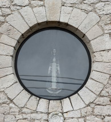 Zdjęcie nr 11: Kościół Najświętszej Marii Panny Królowej jest zlokalizowany w centrum Będkowic, na zachód od głównej drogi. Teren przykościelny jest otoczony wysokim murem posadowionym na kamiennej podmurówce oraz słupkach z nieregularnych ciosów kamienia i z żeliwnym płotem. W części wschodniej muru zlokalizowana jest szeroka brama, do której prowadzą schody, druga brama usytuowana jest nieco z prawej strony, również od wschodu.

Kościół jest skierowany na zachód, murowany, jednonawowy na rzucie prostokąta z prezbiterium zamkniętym półkoliście. Wnętrze tworzy szeroka nawa nakryta stropem oraz węższe i krótkie prezbiterium. Od północy przylega niewielka zakrystia na planie prostokąta z oknem od południa. Wejście do zakrystii zaznaczone jest drewnianym portalem. Na wschodniej ścianie nawy chór muzyczny, wsparty na dwóch słupach, dostępny klatką schodową od nawy. 

Nawę oświetlają dwa duże, rozglifione, prostokątne i zamknięte półkoliście okna umieszczone w południowej oraz północnej ścianie, a także dwa mniejsze okna ulokowane pod chórem zamknięte łukami odcinkowymi. Po bokach prezbiterium są dwa okrągłe okna. Wszystkie otwory okienne w nawie i prezbiterium wypełnione są witrażami lub ozdobnymi przeszkleniami. Do kościoła prowadzi główne wejście od strony wschodniej oraz jedno mniejsze od zakrystii.

Wygląd zewnętrznej elewacji kościoła jest skromny. Prezbiterium niższe od nawy, nad środkiem nawy wznosi się wieżyczka na sygnaturkę z latarnią, nakryta iglicą. Fasada prosta, w dolnej części wejście główne do świątyni, prostokątne, zamknięte łukiem półkolistym, powyżej okrągłe okno, a po bokach dwa mniejsze, prostokątne, zamknięte łukiem odcinkowym. W zwieńczeniu prostokątna, przeszklona, zamknięte półkoliście wnęka z figurą Chrystusa Frasobliwego, a na szczycie prosta aedikula z prześwitem, w której zawieszony jest mały dzwon. U góry łaciński krzyż na cokole. Otwory okienne i drzwiowe zdobione są kamienną okładziną. Świątynia nakryta jest dachem dwuspadowym.

