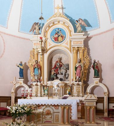 Zdjęcie nr 2: Ołtarz przyścienny, architektoniczny, jednoosiowy, jednokondygnacyjny ze zwieńczeniem, z bramkami. Mensa drewniana, prostopadłościenna zwężająca się ku dołowi. Antepedium z dekoracją płycinową wypełnioną marmoryzacją; w centrum medalion mieszczący złocony, równoramienny krzyż. Tabernakulum o formach architektonicznych ujęte ustawionymi ukośnie, zdwojonymi kolumienkami o kanelowanych trzonach dźwigającymi odcinki pełnego belkowania. W części centralnej zwieńczenie w formie gzymsu wygiętego w łuk wyniesiony. Na szczycie prosty tron wystawienia. Drzwiczki metalowe, fakturowane z przedstawieniem krzyża i monogramem XP na skrzyżowaniu ramion, w otoczeniu kłosów oraz winnych gron. Nad drzwiczkami odlewany medalion z przedstawieniem Baranka na tle krzyża. 

Nastawa ustawiona na wysokim, zdwojonym cokole o licach wypełnionych płycinami z marmoryzacją oraz rzeźbionym, złoconym akantem. Kondygnacja ujęta zdwojonymi, złoconymi, kompozytowymi kolumnami, przed którymi znajdują się wysunięte postumenty z figurami węgierskich królów: św. Stefana po lewej stronie i św. Władysława po prawej stronie. Podpory dźwigają odcinki pełnego, przerwanego nad polem głównym belkowania z szerokim fryzem i wydatnym gzymsem dekorowanym kostkowaniem, wyniesionym w formę półkolistego łuku w zwieńczeniu. W polu głównym rzeźba św. Marcina, a na zasuwie obraz „Wizja św. Franciszka”. Kondygnacja ujęta po bokach złoconymi, akantowymi uszami oraz bramkami w formie półkolistych arkad  wspartych na kompozytowych filarach o trzonach dekorowanych podłużnymi płycinami wypełnionymi marmoryzacją. Na osi bramek cokoły w formie impostów, na których ustawione są figury: św. Piotra po lewej stronie i św. Pawła po prawej. W zwieńczeniu tondo z płaskorzeźbą Trójcy Świętej. W podłuczu zamykającej arkady wolutowe, złocone konsolki. Całość zamknięta złoconym krzyżem ujętym ażurową dekoracją z akantu. Po bokach, na odcinkach belkowania pełnoplastyczne, polichromowane figury klęczących aniołów. Struktura malowana na jasny beż, płyciny wypełnione marmoryzacją w odcieniach łososiowego różu, ornamentyka oraz załamania profili architektonicznych złocone, detale srebrzone.