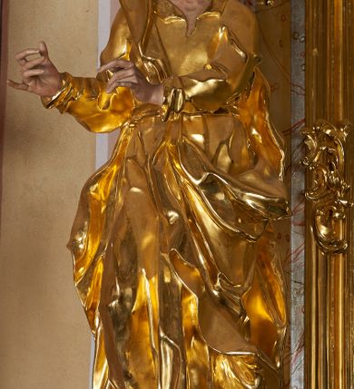 Zdjęcie nr 11: Nastawa ołtarzowa architektoniczna, jednoosiowa, jednokondygnacyjna ze zwieńczeniem. Mensa drewniana o profilowanej krawędzi. Ołtarz  sarkofagowy, na profilowanym cokole; na froncie intarsjowany wzór geometryczny. Kondygnacja ustawiona na cokole, ujęta parą zdwojonych filarów o kapitelach kompozytowych. Podpory dźwigają pełne belkowanie, wyłamane na ich osi, o wklęsło-wypukłym fryzie i silnie wysuniętym gzymsie oraz przerwany wolutowy przyczółek. W polu środkowym profilowana rama w formie stojącego prostokąta zamkniętego łukiem segmentowym nadwieszonym z uskokiem, z obrazem „Zwiastowanie”. Przed filarami, na wklęsło-wypukłych postumentach dwie figury niezidentyfikowanych świętych. Zwieńczenie w formie leżącego prostokąta ujętego spływami wolutowymi, zamkniętego falistym gzymsem przechodzącym w zwrócone przeciwstawnie woluty. W polu rama o fantazyjnej formie zbliżonej do trójkąta z obrazem „Nawiedzenie św. Elżbiety”. Trzony filarów dekorowane kampanulami. W polu środkowym w przyłuczach ornament rocaille'owy. Rama obrazu na dłuższych bokach zdobiona rocaille'm. Nad polem środkowym na belkowaniu rocaille'owy kartusz z napisem w polu „Ave Maria gratia / Plena Dominus tecum / Luea. Ʌ”. W partii fryzu, na osiach podpór z trzech stron rozety. Struktura w całości laserunkowa, srebrzona, marmoryzowana; ornamentyka i profile złocone.