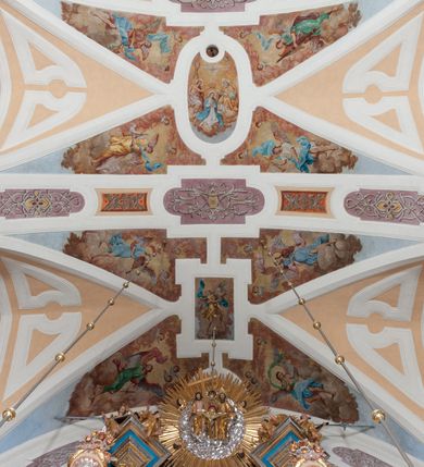 Zdjęcie nr 54: Kościół należy do zespołu dróżek Matki Boskiej, położnych w obrębie klasztoru w Kalwarii Zebrzydowskiej. Świątynia jest położna w centrum wsi, na wschód od głównej drogi, na placu otoczonym kamiennym murem z żeliwnym płotem, który od frontu ozdobiony jest figurami 12 apostołów, umieszczonymi na wysokich cokołach. Główne wejście na plac prowadzi przez bramę od zachodu, flankowaną dwoma filarami, na których ustawione są klasycystyczne wazony. Drugie wejście usytuowane jest od wschodu przez murowaną bramę, nakrytą daszkiem dwuspadowym, na którym ustawiona jest figura grającego na trąbie anioła. Trzecie wejście znajduje się od północy.

Kościół jest budowlą orientowaną, założoną na planie prostokąta, jednonawową, zamkniętą półkolistą absydą. Od zachodu przylega kruchta na planie prostokąta, zamkniętego z jednej strony półkoliście. Wewnątrz kościół dwupiętrowy. Na parterze część wschodnia świątyni podniesiona jest o siedem stopni, oddzielona od nawy trzema półkolistymi arkadami, wspartymi na czterech filarach i ustawionymi przed nimi półkolumnami, które wspierają pełne belkowanie, wyłamane na osiach. W przyłuczach płskorzeźbione główki aniołków. Na fryzie złocony napis: „EIA ADVOCATA NOSTRA OCVLOS MISERICORDES AD NOS CONVERTE ET IESVM BENEDICTV FRCTVM NOBIS OSTENDE”. Za środkową arkadą usytuowana jest niewielka, najstarsza część świątyni – Grób Matki Boskiej, na rzucie prostokąta, sklepiony krzyżowo. W ścianach bocznych nawy są półkoliście zamknięte wnęki na ołtarze. Od zachodu chór muzyczny wsparty jest na trzech arkadach filarowych. Wnętrze obiega drewniany ganek wsparty na metalowych wspornikach, a w części wschodniej i zachodniej na trzech murowanych arkadach. Podniebienie ganku zdobione jest geometrycznym stiukiem. W części nawowej świątyni znajduje się sklepienie kolebkowe z lunetami, w apsydzie hemisferyczne. Wnętrze doświetlone jest sześcioma małymi, okrągłymi oknami znajdującymi się na piętrze od strony północnej i południowej.

Fasada w dolnej części zaakcentowana jest przez monumentalną kruchtę w formie aediculi, założoną na rzucie prostokąta zamkniętego półkoliście. Ściany artykułowane są pięcioma półkolistymi arkadami, wspartymi na filarkach. Od zewnątrz osie ujęte są przez kanelowane kolumny, ustawione na wysokich cokołach, na tle pilastrów. Podpory wznoszą pełne belkowanie i wysunięty gzyms zdobiony kimationem i dekoracją kostkową. Nakrycie w formie kopuły półkolistej z latarnią. Belkowanie ozdobione jest dekoracją roślinną i główkami aniołków. Po bokach kruchty wysunięte są fragmenty muru oporowego do połowy wysokości fasady. Powyżej fasada flankowana przez dwie pary pilastrów z jońskimi kapitelami wspierającymi niepełne belkowanie. Pośrodku duże, półkoliste okno z metalową, dekoracyjną kratą. Szczyt trójkątny z oculusem pośrodku. Na szczycie ustawiona jest figura Najświętszej Marii Panny. Świątynia dookoła obwiedziona szerokim murem oporowym, nakrytym daszkiem, o ukośnych ścianach, flankowanych szkarpami, po sześć na każdej ścianie bocznej i dwoma na ścianie zachodniej oraz wschodniej. Powyżej elewacje ujęte pilastrami z kapitelami jońskimi wznoszącymi niepełne belkowanie. Na wschodniej ścianie półkolista apsyda, nakryta półkopułą. Kościół nakryty dachem siodłowym ze zdwojoną, wysoką latarnią pośrodku. Na narożach dachu ustawione wysokie obeliski na cokołach. 

 