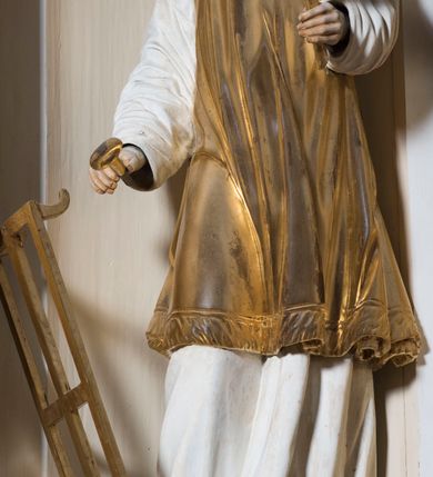 Zdjęcie nr 18: Ołtarz drewniany, prostopadłościenny. Mensa drewniana, sarkofagowa, antepedium zdobione płaskorzeźbionym kartuszem z umieszczonym w polu godłem herbu Uniwersytetu Krakowskiego na czerwonym tle.

 Nastawa architektoniczna, trójosiowa, jednokondygnacyjna ze zwieńczeniem, osadzona na dwustrefowym cokole, o osiach bocznych ustawionych ukośnie. Kondygnacja ujęta parą pilastrów oraz dwiema parami kolumn podtrzymujących przerwane belkowanie,  na którym znajduje się para puttów. W polu środkowym obraz z przedstawieniem Matki Boskiej od Odkupienia Niewolników ujęty prostokątną, profilowaną ramą zamkniętą łukiem nadwieszonym. Na cokole, po bokach obrazu ustawione dwie rzeźby: po lewej św. Kryspina, po prawej św. Kryspiniana; w osiach bocznych, w płytkich wnękach: po lewej rzeźba św. Szczepana, po prawej św. Wawrzyńca. Nad obrazem Matki Boskiej płaskorzeźbiony kartusz rocaille’owy z wpisanym w polu napisem „O / MARYO / odkupicielko / więźniów / módl się / za nami!”.

 Zwieńczenie w formie rozbudowanej aediculi, o osiach bocznych ustawionych ukośnie, z przodu flankowane dwiema wolutami z siedzącą na nich parą aniołków, zamknięte przerywanym, profilowanym gzymsem z ulokowaną na nim parą wazonów płomienistych. W polu zwieńczenia płycina wypełniona obłokami, o fantazyjnym kartuszowym wykroju z przedstawieniem Oka Opatrzności wpisanym w trójkąt na tle trzech wiązek promieni. Szczyt jest w formie promienistej glorii z parą uskrzydlonych główek anielskich.

 Kolumny złocone, ustawione na profilowanych bazach, o gładkim trzonie, kapitele w porządku kompozytowym.

 Partie cokołu zdobione prostokątnymi płycinami o wyciętych narożach.

 Struktura malowana w kolorze jasnobeżowym, ornamentyka i detale złocone i srebrzone, profilowania w kolorze czerwonym i złoconym.