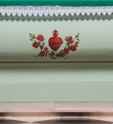 Zdjęcie nr 16: Retabulum ołtarza bocznego charakteryzuje architektoniczna, jednokondygnacyjna, jednoosiowa struktura ze zwieńczeniem. Ołtarz jest drewniany, sarkofagowy z drewnianą mensą. Retabulum osadzone jest na zdwojonym cokole. Część środkowa nastawy ujęta jest parą kolumn i dwoma parami pilastrów, z których jedna ma wklęsłe trzony. Wspomniane elementy wspierają wyłamujące się ponad nimi wklęsło-wypukłe belkowanie. Pole środkowe retabulum jest w kształcie stojącego prostokąta zamkniętego półkolistym łukiem nadwieszonym z uskokami, ujęte jest profilowaną, złoconą ramą. Zwieńczenie, w kształcie stojącego prostokąta zamknięte jest gzymsem w formie nadwieszonego łuku z uskokami. Pole środkowe stanowi owalny prześwit ujęty profilowaną, złoconą ramą. Po bokach zwieńczenia usytuowany jest przerwany, skośnie ustawiony wolutowy przyczółek. Po środku antepedium znajduje się polichromowane gorejące serce Jezusa ujęte gałązkami czerwonej róży. Pola cokołów zdobi ornamentyka rocaille’owo-akantowa. Część środkową retabulum ujmuje para ażurowych uszaków z liści akantu z motywami kogucich grzebieni. Trzony wklęsłych pilastrów w dolnej partii zdobią motywy wolut zwieńczonych liśćmi akantu. W górnej partii trzonów wszystkich pilastrów znajdują się podwieszenia w formie związanych wstążkami kompozycji kwiatowo-owocowych. Kapitele zdobione są detalami ze stylizowanych liści akantu oraz niewielkimi konsolkami z motywem palmety. Fryz dekorują motywy ornamentyki rocaille’owej. Krawędź gzymsu zwieńczenia ujęta jest rodzajem lambrekinu z pojedynczych liści o lancetowatym kształcie. W prześwit wkomponowana została promienista gloria z monogramem Jezusa pośrodku, na ciemnoczerwonym tle, ujęta wieńcem srebrzonych obłoków. W polu części środkowej retabulum znajduje się obraz Najświętsze Serce Jezusa, dodatkowo po bokach, na półkoliście wysuniętych partiach cokołu retabulum usytuowana jest para niewielkich rzeźb św. Rocha i św. Grzegorza Wielkiego. Na przerwanym przyczółku znajduje się para figur aniołów. 
Struktura retabulum utrzymana jest w pastelowym odcieniu turkusu z akcentem ciemnej czerwieni, partie detalu architektonicznego i ornamentyka są złocone i srebrzone.    
