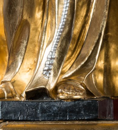 Zdjęcie nr 25: Nastawa architektoniczna, jednoosiowa, jednokondygnacyjna ze zwieńczeniem, na wysokim cokole z wyodrębnionymi konsolami. Ołtarz drewniany, sarkofagowy, na cokole, zwężający się ku dołowi z drewnianą mensą i kamiennym portatylem. Na mensie ustawione tabernakulum w formie prostopadłościennej skrzynki. Ścianka frontowa ujęta ornamentalnymi listewkami; drzwiczki w kształcie stojącego prostokąta w ornamentalnej ramie z płaskorzeźbionym przedstawieniem kielicha z hostią i winnym gronem. Nastawa ujęta parą zdwojonych pilastrów zwróconych pod kątem na zewnątrz, dekorowanych zwisami kwiatowymi, dźwigających silnie wysunięte imposty podtrzymywane przez konsole. Na tle pilastrów figury św. Antoniego Padewskiego i św. Franciszka ustawione na konsolach. W polu środkowym obraz św. Franciszka w formie stojącego prostokąta ujęty profilowaną ramą zdobioną rocaille'em. Powyżej wolutowe fragmenty rocaille'u, pod nim płycina. Zwieńczenie w formie trapezu ujętego spływami wolutowymi, dekorowanymi liśćmi palmowymi, ze ślimacznicami w kształcie meandru, spływającymi na belkowanie, na których stoją wazony. Całość zamknięta fragmentem wyłamanego trójbocznie gzymsu, zwieńczonego rokokowym szczytem z kwiatowymi gałązkami. W polu obraz św. Franciszki Rzymskiej w formie zbliżonej do zwieńczenia, ujęty ramą dekorowaną rocaille'em. Struktura polichromowana w kolorze głębokiej czerwieni, z czarnymi profilami oraz złoconymi ramami, profilami i ornamentyką.
