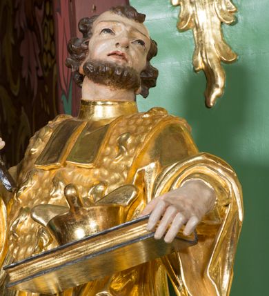 Zdjęcie nr 21: Nastawa ołtarzowa architektoniczna, jednoosiowa, jednokondygnacyjna ze zwieńczeniem. Mensa sarkofagowa, dekorowana na froncie dwiema płycinami w kształcie leżących prostokątów, ujętych po bokach i spiętych motywem ornamentalnym utworzonym z rocaille’a i liści. Oś nastawy flankowana pilastrami przechodzącymi dołem w konsole i górą we fragmenty pełnego belkowania, o delikatnie wklęsło-wypukłej linii gzymsu. Zwieńczenie w formie wklęsło-wypukłej ujęte spływającymi na belkowanie dużymi wolutami, zamknięte stylizowanym gzymsem z ceowników i zwieńczone wyobrażeniem oka Opatrzności, na tle glorii promienistej i obłoków. W polu środkowym pierwszej kondygnacji rzeźba ukazująca św. Mikołaja przesłaniana obrazem z przedstawieniem św. Antoniego Padewskiego adorującego Matkę Boską z Dzieciątkiem wykonanym w 1830 roku przez nowotarskiego malarza Tomasza Nankego, na zamówienie organisty Jakuba Pasigowskiego. Nisza ujęta profilowaną ramą w formie stojącego prostokąta zamkniętego łukiem półkolistym nadwieszonym z uskokiem, dekorowana fragmentami rocaille’ów. Na konsolach figury św. Jana Nepomucena po lewej stronie i św. Karola Boromeusza po prawej. W polu zwieńczenia obraz z przedstawieniem św. Agaty ujęty ramą w formie trójlistnej, dekorowaną fragmentami rocaille'ów i flankowaną kwitnącymi gałązkami. Brzeg zwieńczenia i woluty zdobione taśmą i rocaille'ami, na wolutach para siedzących puttów, na zwieńczeniu uskrzydlone główki anielskie. 
Struktura polichromowana w kolorze zielonym, z marmoryzowanym cokołem i płycinami; ornamentyka i profile złocone i srebrzone.
