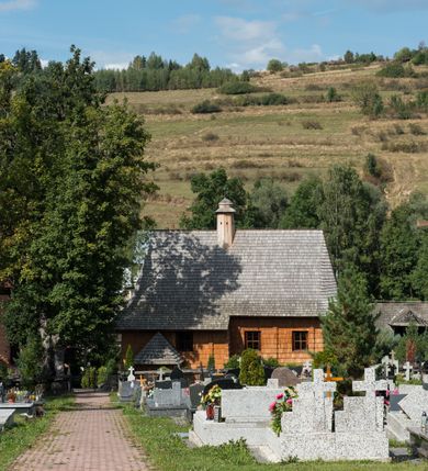 Zdjęcie nr 4: Kościół św. Elżbiety Węgierskiej w Trybszu usytuowany jest w centrum wsi na południe od drogi prowadzącej z Łapsz Wyżnych do Nowego Targu. Teren przykościelny jest otoczony od południa drewnianym ogrodzenie z murowanymi słupkami i kamienną podmurówką, z pozostałych stron mur z polnych kamieni, nakryty daszkiem cementowym. Główne wejście na teren przykościelny od północy, od zachodu bramka prowadząca do nowego kościoła, od południa furtka na cmentarz. Od zachodu główne wejście flankowane słupkami. Na placu przykościelnym stara lipa, w niej krucyfiks w kapliczkowej, szafkowej oprawie. W zachodniej części sztuczna grota, murowana z polnych kamieni z figurą Matki Boskiej z Lourdes. 

Kościół jest orientowany, drewniany o konstrukcji zrębowej, jednonawowy z wydłużonym prezbiterium zamkniętym trójbocznie, z kruchtą od południa i pierwotnie z zakrystią od północy i wieżą od zachodu. Wnętrze nakryte pułapem, w nawie z zaskrzynieniami, wiązanie nawy oparte nie na ścianach lecz na belkach podciągowych, których jeden koniec jest w ścianie tęczy, drugi zaś w czołowej ścianie nawy. Na zachodniej ścianie nawy chór muzyczny wsparty na dwóch filarach. Wnętrze oświetlają umieszczone w południowej ścianie trzy okna (dwa w prezbiterium i jedno w nawie). Ściany i stropy pokryte polichromią. Do kościoła prowadzi główne wejście od strony zachodniej oraz jedno przez kruchtę od południa. Dach o jednej kalenicy, gontowy, na środku drewniana sygnaturka, nakryta kopułką. Portal do zakrystii o wykroju w tzw. ośli grzbiet. 

