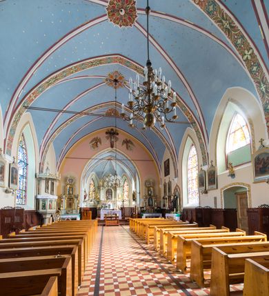 Zdjęcie nr 14: Kościół św. Antoniego Padewskiego w Trybszu jest usytuowany w centrum wsi, na południe od głównej drogi prowadzącej z Łapsz Wyżnych do Nowego Targu. Teren przykościelny jest otoczony wysokim murem, częściowo żeliwnym na kamiennej podmurówce, częściowo murowanym nakrytym cementowym daszkiem. Wejście od strony wschodniej oraz zachodniej przez szerokie bramy.

Kościół jest orientowany, murowany, otynkowany, jednonawowy z czworoboczną wieżą w fasadzie z prezbiterium zamkniętym trójbocznie. Dwuprzęsłowe prezbiterium oddziela od nawy szeroka ściana arkady tęczowej, zamknięte ostrołukowo. Nawa jest szersza i dłuższa, pięcioprzęsłowa. Wnętrze artykułowane jest dużymi i szerokimi oknami w kształcie stojących prostokątów, zamkniętych ostrołukowo, wypełnionych witrażami. Od południa do nawy przylega niewielka kruchta, a do prezbiterium od północy zakrystia. Na zachodniej ścianie nawy chór muzyczny wsparty na dwóch filarach, dostępny schodami od południowej strony nawy. Do kościoła prowadzi główne wejście od strony zachodniej oraz dwa mniejsze od strony południowej przez kruchtę i od strony północnej przez zakrystię.

W zewnętrznej elewacji kościoła widoczny jest niewysoki cokół, powyżej kościół otynkowany. Prezbiterium, o tej samej wysokości co nawa, lecz węższe z sygnaturką zwieńczoną iglicą. Nawa i prezbiterium oszkarpowane, nakryte dachem dwuspadowym. Do zachodniej fasady kościoła dostawiona jest wysoka założona na planie kwadratu wieża-dzwonnica. W dolnej kondygnacji na osi kościoła prostokątne wejście do kruchty, flankowane dwiema szkarpami. Fasada wieży w całości pokryta blachą, przechodzącą nad głównym wejściem do kościoła w daszek. Wieża zwieńczona iglicą.
