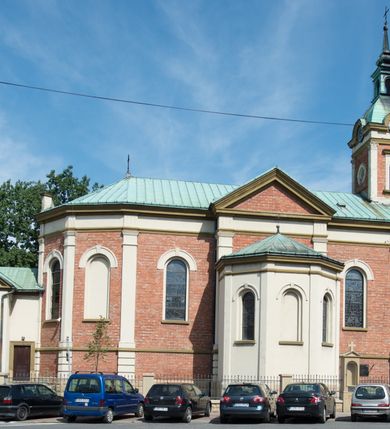 Zdjęcie nr 37: Kościół murowany, jednonawowy, z węższym prezbiterium zamkniętym trójbocznie oraz z wieżą wbudowaną w zachodnią fasadę. Do prezbiterium od północy przylega zakrystia, do nawy dwie kaplice leżące po przeciwległych stronach, zamknięte trójbocznie, od zachodu chór wsparty na dwóch filarach, z trójczęściową balustradą wychodzącą do przodu. Korpus trójprzęsłowy, przęsła oddzielone opilastrowanymi filarami podtrzymującymi arkady sklepienia. Nad kaplicami i prezbiterium fragmenty sklepienia gwiaździstego, nad nawą żaglaste. Wielobarwna polichromia  ścian i sklepień wypełnia podziały wyznaczone przez elementy architektoniczne, opiera się na motywach geometrycznych, stylizowanych floralnych, zoomorficznych i postaciach aniołów i świętych . Wszystkie okna w kształcie stojącego prostokąta zamkniętego półkoliście, w większości witraże, dwa w prezbiterium, po trzy z każdej strony nawy, po dwa w kaplicach, dwa na wysokości chóru, cztery w kondygnacji wieży; wyjątek stanowi okulus w fasadzie. Główne wejście przez fasadę, kolejne do zakrystii. Fasada dwukondygnacyjna, trójosiowa, na cokole, z wieżą. Osie wydzielone pilastrami, z których środkowa mieści drzwi o wykroju prostokąta i okulus w czworobocznej płycinie, a boczne zamknięte konchowo nisze w figurami św. Piotra po lewej i św. Pawła po prawej stronie. Kondygnacja zamknięta zdwojonym przyczółkiem. Wewnętrzny przerwany na kartusz herbowy i okrągłą plakietę z krzyżem, zewnętrzny na kondygnację wieży.  Wieża z każdej strony przepruta oknem zwieńczonym fragmentem gzymsu, na narożach ujęta pilastrami podtrzymującymi belkowanie z linią gzymsu wyoblającą się w środku i ujmującą tarczę zegara. Pozostałe elewacje na kamiennym cokole, nawa i prezbiterium z nietynkowanej cegły, kaplice i zakrystia otynkowane. Kontynuują podziały  pilastrami, artykulację podkreślają okna.  Dach nad nawą główną dwuspadowy, nad kaplicami i prezbiterium wieloboczne, wieża przekryta hełmem z latarnią, zwieńczona ostrosłupem z krzyżem.  
Najcenniejszym zabytkiem świątyni jest ołtarz główny z około 1700 roku przeniesiony tutaj z kościoła z Limanowej, interesująca jest polichromia o inspiracjach młodopolskich z elementami art  decó. 

