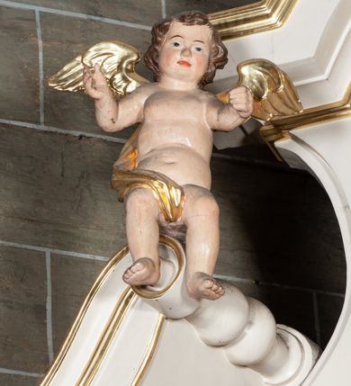 Zdjęcie nr 9: Ołtarz jednoosiowy, jednokondygnacyjny, ze zwieńczeniem. Mensa umieszczona na tumbie zwężającej się ku dołowi, ozdobionej od czoła płyciną prostokątną w złoconym obramieniu, pośrodku ze splecionymi literami imienia Maria. Nastawa flankowana ustawionymi ukośnie czworobocznymi, kanelowanymi filarami, dźwigającymi odcinki pełnego belkowania i gzymsu, przerwanych nad polem środkowym. Na tle filarów umieszczone na konsolach rzeźby: św. Stanisława Kostki (po lewej) i św. Ignacego Loyoli (po prawej). W polu środkowym, nad mensą zawieszony obraz w ozdobnej ramie z przedstawieniem św. Stanisława Kostki w półpostaci; wyżej prostokątna nisza, w której obraz Matki Boskiej z Dzieciątkiem. Zwieńczenie w kształcie aediculi zamkniętej łukiem półkolistym nadwieszonym, w której polu obraz z przedstawieniem św. Józefa w półpostaci. Po bokach, w osiach filarów odcinki przerwanego przyczółka na których rzeźby nagich, uskrzydlonych puttów.  Na gzymsie wieńczącym ołtarz Gołębica Ducha Świętego wśród promieni.