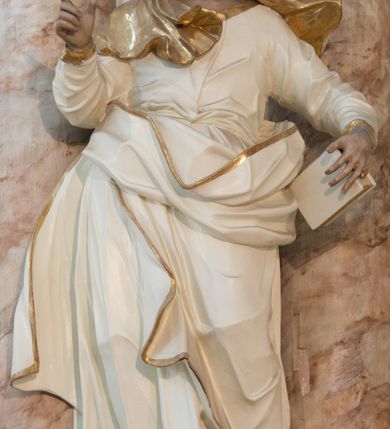 Zdjęcie nr 29: Nastawa architektoniczna, trójosiowa, dwukondygnacyjna ze zwieńczeniem, ustawiona na dwustrefowym cokole. Ołtarz drewniany, prostopadłościenny z drewnianą mensą, w partii antepedium dekorowany trzema płycinami. Na ołtarzu ustawione tabernakulum. Cokół dwustrefowy z wyodrębnionymi prostopadłościanami dekorowanymi w pierwszej strefie płycinami, w drugiej rocaille'owymi płycinami.  Osie pierwszej kondygnacji wydzielone trzema parami kolumn. Oś środkowa flankowana dwiema parami pilastrów i stojącymi przed nimi kolumnami ustawionymi na cokołach, druga para zwrócona pod kątem na zewnątrz. Podpory dźwigają wyłamane na ich osi fragmenty belkowania, środkowa para również przerwany, falisty przyczółek. Na belkowaniu i przyczółku siedzi para puttów i para adorujących aniołów. Pomiędzy parami kolumn ustawione figury św. Anny i św. Elżbiety. W polu głównym znajduje się wnęka w formie stojącego prostokąta zamkniętego łukiem półkolistym nadwieszonym z uskokiem, ujęta profilowaną ramą z obrazem Matki Boskiej z Dzieciątkiem i św. Janem Chrzcicielem. Ponad obrazem rokokowy kartusz z kwiatowymi zwisami, z napisem „EN! / PORTA PATET CURIAE / DEI EXCELSA MATER ET / VIRGO IO! VENITE / S(anctus) Cyprianus”. Osie boczne wydzielone zewnętrzną parą pilastrów i stojących przed nimi kolumn ustawionych na dwustrefowych cokołach, dźwigających imposty i fragmenty przerwanego rocaille'owego przyczółka. Na osiach w partii cokołu znajdują się bramki z drzwiami w kształcie stojącego prostokąta zamkniętego łukiem półkolistym. Ponad nimi na rocaille'owych konsolach, na tle wnęki ujętej rocaille'ową ramą znajdują się figury św. Joachima i Zachariasza. Nad wnękami ażurowa kratka w formie stojącego prostokąta ujęta rocaille'ową ramą. Całość zamknięta rocaille'm z wyodrębnionym pionowym akcentem koguciego grzebienia. Druga kondygnacja flankowana dwiema parami pilastrów, w tym zewnętrzną ustawioną pod kątem na zewnątrz o trzonach przechodzących w spływy wolutowe ustawione na cokołach na belkowaniu pierwszej kondygnacji nastawy. Spływy zakończone są rokokowymi wazonami. Podpory dźwigają gzyms przerwany na polem. Całość zamknięta medalionem z Okiem Opatrzności otoczonym wieńcem z obłoków i uskrzydlonych główek anielskich, w glorii promienistej. U dołu medalionu i na gzymsie znajdują się putta. W polu wnęka w formie stojącego prostokąta zamkniętego łukiem półkolistym nadwieszonym w profilowanej ramie z obrazem św. Kazimierza. Struktura niemal w całości polichromowana w kolorze białym, trzony kolumn polichromowane na sposób imitujący marmoryzację w kolorze biało-różowym, profile i ornamentyka złocone. 