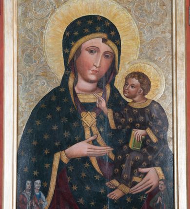 Zdjęcie nr 3: Tryptyk z wizerunkiem Matki Boskiej z Dzieciątkiem w środkowej kwaterze, ze skrzydłami z przedstawieniami na awersie św. Katarzyny i św. Barbary, a na rewersie św. Mikołaja i św. Stanisława. Środkowa kwatera w formie stojącego prostokąta z przedstawieniem Marii ukazanej w półpostaci, zwróconej w trzech czwartych w lewo, z pochyloną głową. Na lewym ramieniu podtrzymuje siedzące Dzieciątko, prawą dłonią wskazuje na nie. Twarz ma owalną, o migdałowatych oczach, prostym, wąskim nosie i małych, pełnych ustach. Ubrana jest w niebieską suknię, ze złoconymi lamówkami oraz ciemnoniebieski maforion w złocone gwiazdy, ze złoconymi lamówkami i ciemnoczerwoną podszewką, narzucony na głowę i ramiona, zapięty złoconą klamrą pod szyją. Dzieciątko ukazane w pozycji siedzącej, pochylone, zwrócone w trzech czwartych w prawo, lewą ręką opiera księgę na nodze, prawą wyciąga przed siebie w geście błogosławieństwa. Twarz ma owalną, o dużych, migdałowatych oczach, krótkim nosie i pełnych ustach, okoloną jasnymi, kręconymi i krótkimi włosami. Dzieciątko ubrane jest w luźną ciemnoniebieską tunikę o złoconym, kwiatowym wzorze, ze złoconym galonem. Postacie ukazane na złoconym i srebrzonym tle z rytą w zaprawie wicią roślinną z kwiatami. Wokół ich głów ryte w zaprawie nimby. W lewym dolnym rogu obrazu ukazane niewielkie postacie dwóch klęczących kobiet, zwróconych w trzech czwartych w lewo, z dłońmi złożonymi w geście modlitwy, z różańcami. W prawym dolnym rogu ukazany niewielki klęczący mężczyzna, zwrócony w trzech czwartych w prawo, z dłońmi złożonymi w geście modlitwy. 
Na awersie lewego skrzydła przedstawienie św. Katarzyny Aleksandryjskiej ujętej w całej postaci, zwróconej w trzech czwartych w lewo, z pochyloną głową, stojącej na postaci swojego oprawcy. W lewej, ugiętej na tle piersi ręce trzyma miecz, skierowany ostrzem w górę, prawą, opuszczoną w dół przytrzymuje przy boku koło. Twarz ma owalną, o wysokim czole, małych, migdałowatych oczach, prostym, krótkim nosie i małych ustach, okoloną długimi, brązowymi włosami, opadającymi wzdłuż ramion. Na głowie ma koronę otwartą. Ubrana jest w jasnozieloną suknię oraz jasnozielony, obfity płaszcz z czerwoną podszewką, zapięty pod szyją broszą, zarzucony na ramiona i podtrzymywany z przodu postaci. Święta stoi na niewielkiej postaci leżącego mężczyzny, ubranego w bogaty, ciemnoniebieski strój, ze złoconym pazem, z koroną otwartą na głowie. Katarzyna ukazana na złoconym i srebrzonym tle z rytą w zaprawie wicią roślinną z kwiatami. Wokół jej głowy ryty w zaprawie nimb. 
Na awersie prawego skrzydła przedstawienie św. Barbary ukazanej w całej postaci, zwróconej w trzech czwartych w prawo, z pochyloną głową, stojącej na postaci swojego oprawcy. W prawej, wyciągniętej przed siebie ręce podtrzymuje wieżę, lewą trzyma płaszcz. Twarz ma owalną, o wysokim czole, małych, migdałowatych oczach, prostym, krótkim nosie i małych ustach, okoloną długimi, jasnobrązowymi włosami, opadającymi wzdłuż ramion. Na głowie ma koronę otwartą. Ubrana jest w ciemnoniebieską suknię, przepasaną w talii oraz czerwony płaszcz z zieloną podszewką, zapięty pod szyją broszą, zarzucony na ramiona i podtrzymywany z przodu postaci. Święta stoi na niewielkiej postaci leżącego mężczyzny, ubranego w bogaty, ciemnoniebieski strój. Barbara ukazana na złoconym i srebrzonym tle z rytą w zaprawie wicią roślinną z kwiatami. Wokół jej głowy ryty w zaprawie nimb. 
Na rewersie lewego skrzydła przedstawienie św. Mikołaja ukazanego w całej postaci, zwróconego w trzech czwartych w lewo. W lewej ręce trzyma pastorał, prawą unosi w geście błogosławieństwa. Twarz ma pociągłą, o małych, migdałowatych oczach, prostym nosie i wąskich ustach, okoloną, krótką kręconą brodą i siwymi, krótkimi włosami skręconymi w pukle. Na głowie ma białą infułę z brązową opaską. Ubrany jest w białą albę, zieloną rokietę oraz obfity, niebieski ornat z czerwoną podszewką. Wokół jego głowy jasnożółty nimb. Święty ukazany jako stojący na trawie, z jednolitym, ciemnoczerwonym tłem. 
Na rewersie prawego skrzydła przedstawienie św. Stanisława ukazanego w całej postaci, zwróconego w trzech czwartych w prawo. W prawej ręce trzyma pastorał, lewą podtrzymuje przy boku księgę. Twarz ma pociągłą, o małych, migdałowatych oczach, prostym nosie i wąskich ustach, okoloną krótkimi, brązowymi włosami. Na głowie ma białą infułę z brązową opaską. Ubrany jest w białą albę, zieloną rokietę oraz obfity, czerwony ornat z niebieską podszewką. Wokół jego głowy jasnożółty nimb. Święty ukazany jako stojący na trawie, z jednolitym, ciemnoczerwonym tłem. 
Każdy z trzech obrazów ujęty osobną profilowaną ramą, złoconą z czerwoną obwódką. Skrzydła przymocowane do środkowej kwatery dwoma parami zawiasów. 
