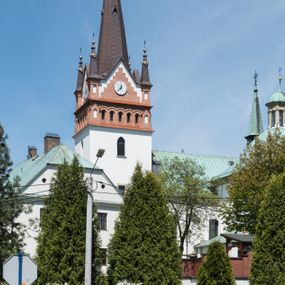Zdjęcie nr 1: Kościół orientowany, jest budowlą murowaną z cegły i kamienia, na rzucie podłużnym. Korpus jednonawowy i trójprzęsłowy. Stosunkowo szerokie, trójprzęsłowe, zamknięte trójbocznie prezbiterium z przylegającą od północy zakrystią. Na osi kościoła przylega do fasady trójkondygnacyjna wieża z kruchtą w przyziemiu i przyległością od południa, w której mieszczą się prowadzące na wieżę schody.  Od południa i zachodu, na wysokości trzeciego przęsła do korpusu przylega kaplic na rzutach zbliżonych do kwadratów, z czego południową od wschodu i zachodu flankuje para krucht. Nawa, prezbiterium i kaplica północna przekryte są sklepieniami kolebkowymi z lunetami wspartymi na parach lub pojedynczych pilastrach. Kaplica południowa nakryta jest kopułą wspartą na 4 pendentywach. Artykulację ścian na zewnątrz korpusu nawowego i prezbiterium stanowi zespół przypór. Naroża kaplicy południowej ujmują zwielokrotnione pilastry wpierające obiegający bryłę gzyms wieńczący. Naroża kaplicy północnej ujmuje para neogotyckich przypór, natomiast północną ścianę wieńczy neogotycki szczyt schodkowy. 
Do wnętrza prowadzi 6 otworów drzwiowych – 1 w kruchcie w wieży ujęte kamienny, półkoliście zamkniętym portalem schodkowym z dwuskrzydłowymi drzwiami z nadświetlem, 1 zamknięte łukiem półkolistym w przyległości obok wieży, 3 w kruchtach flankujących kaplicę południową – z czego w zachodniej jedno w formie dużych dwuskrzydłowych drzwi z kwaterami bocznymi i nadświetlem, we wschodniej 2 ujęte prostokątnymi, kamiennymi portalami z wąskim nadświetlem i parą uszaków, zwieńczonych parą stykających się wolut z krzyżem na kuli w szczycie oraz 1 prowadzące do zakrystii. Okna korpusu nawowego i prezbiterium w kształcie stojących prostokątów zamkniętych półkoliście, z czego w prezbiterium są smukłe i wysokie. Okna kaplicy północnej zamknięte łukiem koszowym, natomiast kaplicy południowej w postaci prostokątów ujętych kamiennymi obramieniami z uszakami na narożach. 3 z 4 ścian wieży przeprute oknami, po 1 na każdej z kondygnacji, z czego na pierwszej zamknięte półkoliście, na drugiej w kształcie stojącego prostokąta i na trzeciej ostrołukowe. Wieżę wieńczy ceglany szczyt z wydzielonym gzymsami fryzem arkadkowym, wyżej 4 trójkątne szczyty umieszczone na osiach każdej ze ścian ujęte w narożach 4 małymi pinaklami i hełmem pośrodku w formie wysokiego pinakla. Korpus nawowy i prezbiterium przekrywa dach dwuspadowy, kryty blachą, z pinaklową wieżyczką na sygnaturkę na połączeniu tych przestrzeni, kaplicę południową kopuła z latarnią, przylegające do niej kruchty dachy pulpitowe, natomiast kaplica północna ma dach dwuspadowy. Otynkowane ściany kościoła są pomalowane w kolorze białym, miejscami pozostawiony kamienny mur.     
