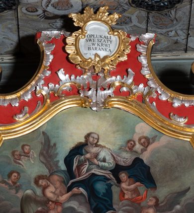 Zdjęcie nr 3: Obraz w kształcie stojącego prostokąta o dolnej i górnej krawędzi zamkniętymi łukiem wklęsło-wypukłym z uskokami. Scena wielofigurowa, dwustrefowa. W dolne strefie, na osi obrazu prostopadłościenny, kamienny, otwarty sarkofag z namalowaną datą „1775”. Wokół grupa stojących i przyklękających jedenastu apostołów, dwaj z nich (św. Jakub Większy i św. Jan Ewangelista) wyjmują z sarkofagu białą tkaninę, pokrytą białymi kwiatami. W górnej partii unosząca się na obłokach Maria, ukazanej frontalnie, z głową w trzech czwartych zwróconą w lewo ze złożonymi na piersiach rękami. Twarz zaokrąglona, o delikatnych rysach, jasnej karnacji i silnie zarumienionych policzkach. Włosy długie, falowane, jasnobrązowe, opadające na plecy i ramiona. Maria ubrana jest w białą, długą, przepasaną suknię i rozwiany, ciemnoniebieski płaszcz z kremowym podszyciem.  Wokół Marii widoczni są wśród obłoków aniołowie oraz uskrzydlone główki anielskie. Kolorystyka zróżnicowana, nasycona o delikatnym modelunku.  Według dokumentacji konserwatorskiej na odwrociu znajduje się napis „Renovatum A. D. 2013 / wykonana staraniem ks. kustosza / Józefa Stopki / w pracowni konserwatorskiej Muzeum / Archidiecezjalnego / w Krakowie / prowadzonej przez ks. dr A. J. Nowobilskiego . Prace konserwatorskie wykonał zespół: / mgr Dorota Biedrońska-Krówka / mgr Danuta Prząda / tech Beata Paluch / Anna Tłuszcz / Łukasz Żukowski / Aleksandra Koza / Nadia El Bably”. Rama drewniana, profilowana i złocona.

