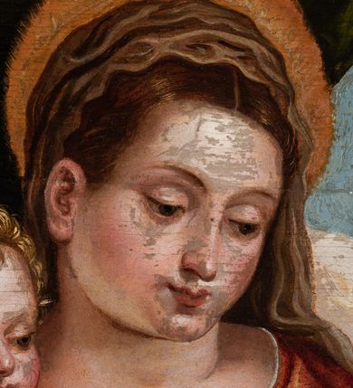 Zdjęcie nr 4: Obraz przedstawiający Matkę Boską z Dzieciątkiem stojącym na jej prawym udzie, siedzącą między stojącymi św. Barbarą z lewej strony i młodym św. Janem Chrzcicielem z prawej. Maria spogląda na jabłko podawane Jezusowi przez św. Jana. Ma okrągłą twarz, ciemne oczy , wąski nos i małe usta. Jest ubrana w czerwoną suknię i niebieski płaszcz ze złotym podbiciem. Jezus sięga w stronę jabłka, ma małą, okrągłą twarz i jasne włosy zwinięte w loki, jest przepasany białą tkaniną powyżej pasa. Święty Jan Chrzciciel został ukazany z profilu, jedną ręką podaje jabłko, w drugiej trzyma krzyż. Ma podłużną twarz z wysokim czołem, małym nosem i ciemnymi oczami, jest ubrany w skórę. Stojąca po drugiej stronie św. Barbara została ukazana lekko z tyłu, w rękach trzyma wieżę, twarz zwraca ku scenie, ma ciemne oczy, wśki nos i małe usta, włosy misternie zaplecione. Jest ubrana w ciemnozieloną suknię z czerwonymi rękawami i przezroczystym materiałem przy dekolcie. Biodra otacza żółty płaszcz. Tło sceny z lewej strony stanowi kotara, z prawej rozległy krajobraz.