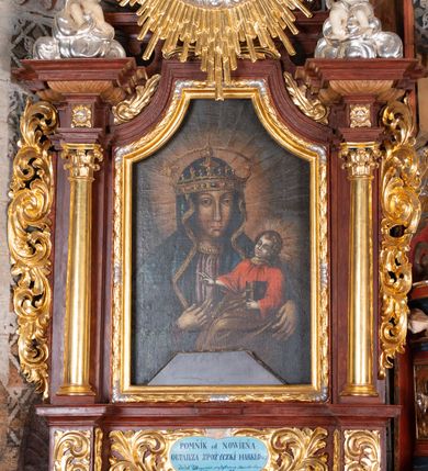 Zdjęcie nr 5: Ołtarz przyścienny, architektoniczny, jednokondygnacyjny, jednoosiowy, ze zwieńczeniem. Mensa w typie sarkofagowym z kamiennym portatylem, dekorowana w dolnej partii srebrnymi liśćmi akantu, a w górnej pośrodku płaskorzeźbiony monogram maryjny ujęty plakietami ornamentalnymi z kształtów nawiązujących do motywu rocaille’a; całość mensy groszkowana. Retabulum na cokole o wysuniętych bokach, ujęte parą kolumn o kapitelach akantowych i gładkich trzonach, wspierających fragmenty belkowania z silnie wysuniętymi fryzem i gzymsem. Pola cokołu retabulum zdobione motywem wici akantowej, z kartuszem w kształcie leżącego owalu pośrodku z ciemnoniebieskim napisem na jasnoniebieskim tle „POMŃIK od NOWIEŃA / OŁTARZA ZPOŻYCZKI HARKLOwy / dodał Utrzymańie przy tej Robocie Stanisław Plewa. / w. 1856”. Oś środkową nastawy wypełnia pole w kształcie stojącego prostokąta o wklęsłych górnych narożach, ujęte profilowaną, częściowo złoconą ramą, z motywem liści laurowych. W polu obraz z przedstawieniem Madonny z Dzieciątkiem. Kondygnację flankują ażurowe uszaki utworzone z bujnej, mięsistej wici akantu. Zwieńczenie tworzy owalne przedstawienie św. Kingi otoczone srebrnymi obłokami oraz glorią promienistą o promieniach różnej długości. Zwieńczenie flankuje para nagich aniołków posadowionych na srebrzonych chmurach, umieszczonych na fragmentach belkowania retabulum. 
Struktura polichromowana w kolorze brązowym. Partie detalu architektonicznego i ornamentyka złocone i srebrzone. 
