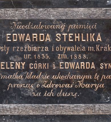 Zdjęcie nr 1: Epitafium o formie leżącego prostokąta z uszakami. Pole z inskrypcją gładkie, prostokątne, z ćwierćkoliście ściętymi rogami, obwiedzione pasem z surowego, nie polerowanego marmuru. W polu inskrypcja „Nieodżałowanej pamięci / EDWARDA STEHLIKA / artysty rzeźbiarza i obywatela m(iasta) Krakowa / ur(odzonego) 1835. zm(arłego) 1888.  / HELENY CÓRKI i EDWARDA SYNA / żona i matka kładzie ukochanym tę pamiątkę / prosząc o Zdrowaś Marya / za ich duszę.”
  
