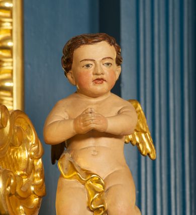Zdjęcie nr 12: Ołtarz drewniany, prostopadłościenny, z kamienną mensą. Antepedium w formie obrazu z przedstawieniem Ostatniej Wieczerzy, ujętego profilowaną ramą. Na ołtarzu ustawione tabernakulum z tronem wystawienia. 
Nastawa architektoniczna, jednokondygnacyjna ze zwieńczeniem, trójosiowa z bramkami, ustawiona na dwustrefowym cokole z wyłamanymi czterema prostopadłościanami. Oś środkowa ujęta dwiema parami pilastrów oraz parą kolumn, na cokołach zwróconych pod kątem do wewnątrz ołtarza. Osie zewnętrzne ujęte parą pilastrów i stojących na ich tle kolumn. Wszystkie podpory dźwigają imposty, na osiach środkowy podpór zwrócone pod kątem do wewnątrz. Na parze skrajnych impostów fragmenty przerwanego, falistego przyczółka. W polu środkowym nisza w formie stojącego prostokąta zamkniętego łukiem półkolistym nadwieszonym, z uskokiem, ujęta profilowaną ramą, z obrazem Nauczania Marii. Na osiach bocznych figury św. Piotra i św. Pawła ustawione na wspornikach Zwieńczenie niearchitektoniczne, o formie zbliżonej do trapezu, o wklęsłych bokach z uszakami, zamknięte fragmentem falistego gzymsu. W polu obraz o fantazyjnej formie zbliżonej do trapezu z przedstawieniem św. Barbary, ujęty ornamentalną ramą. Zwieńczenie flankują dwie figury klęczących aniołów na cokołach. Nastawa dekorowana rocaille'm w przestrzeni nad polem głównym oraz w partii zwieńczenia, ujęta uszami utworzonymi z rocaille'u, kampanuli i ornamentu roślinnego. Na osiach bocznych zwisy kwiatowe. Bramki w formie przejść o wykroju stojącego prostokąta o wklęsłych górnych narożach, zamkniętego dwiema woltami i cokołami z imitacją puklowania, na których stoją figury niezidentyfikowanych monarchów. Struktura polichromowana w kolorze niebieskim, kolumny, profile i ornamentyka złocone. 






