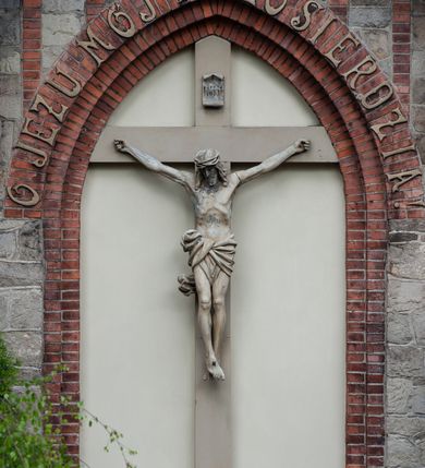 Zdjęcie nr 58: Kościół ceglany, jednonawowy z transeptem. Nawa artykułowana półfilarami i półkolumnami przechodzącymi w gurty sklepienia kolebkowego z lunetami w nawie głównej i żaglowego na przecięciu naw. Na ścianach polichromia na cegle, gurty podkreślone pasami wzorów geometrycznych, sklepienie niebieskie. W nawie i prezbiterium okna w formie biforiów, w transepcie w kształcie stojącego prostokąta zamkniętego łukiem pełnym, z maswerkami, w chórze węższe, zamknięte łukiem ostrym, dwudzielne z rozetą oraz biforia; główne wejście na osi. Chór muzyczny wsparty na masywnych filarach i kolumnach o kapitelach kostkowych z kamiennym parapetem ozdobionym fryzem arkadkowym. Na osi wieloplanowej fasady potężna, trójkondygnacyjna wieża. W pierwszej kondygnacji, po schodach wejście w formie łuku pełnego z drzwiami w formie stojącego prostokąta zamkniętego łukiem dwuramiennym. Obramienie wejścia kamienne, flankowane kolumnami z kostkowymi kapitelami, ze szczytem z chrystogramem. Całość wtopiona w szerszy szczyt, w zwieńczeniu którego rozeta. W trzeciej kondygnacji, zakomponowanej na drugim planie, okno w kształcie stojącego prostokąta zamkniętego łukiem pełnym, dwudzielne z rozetą. Nad nim rzeźba ukrzyżowanego Chrystusa, a w czterech narożach, na konsolach figury św. Stanisława biskupa, św. Stanisława Kostki, św. Jana Kantego i św. Kazimierza Jagiellończyka wykonane z kamienia pińczowskiego przez krakowskiego rzeźbiarza Władysława Druciaka. Wieżę flankują dwie mniejsze, również trójkondygnacyjne wieżyczki dołem czworoboczne, przechodzące w ośmiobok przepruty małymi, prostokątnymi oknami w dwóch niższych kondygnacjach i takimi samymi, naprzemiennie z biforiami w najwyższej. Elewacje transeptu z ogromnymi oknami dekorowanymi maswerkiem, zamknięte trójkątnymi szczytami. Elewacje zewnętrzne z wielobarwnej cegły – w większości ciemnej, dekorowanej na dwóch lub trzech poziomach pasami. Na poziomie pierwszej kondygnacji z jasnej cegły między pasami kamienia, poniżej linii dachu ze wzorem geometrycznym między pasami kamienia, w szczytach jasnym wzorem geometrycznym; chór dekorują blendy arkadkowe. Elewacje opinają ceglane szkarpy, w obejściu zwieńczone kamiennymi kapliczkami. Dachy nawy i transeptu dwuspadowe, dekorowane mozaiką geometryczną, wieloboczna kaplica z dachem sześciokątnym zwieńczonym barokową w kształcie wieżyczką na sygnaturkę, obejście pulpitowym. Do kaplicy przylega przełączka łącząca nowy kościół ze starym.  

Z wyposażenia kościoła na uwagę zasługują obraz Matki Boskiej Suskiej i dwie rzeźby (św. Łukasza i św. Jana Ewangelisty) przeniesione z ołtarza bocznego starego kościoła ustawione na ołtarzu głównym. Sam ołtarz główny (1912) wykonany został przez Antoniego Madeyskiego w Rzymie według rysunków Zygmunta Hendla. Madeyski wykorzystał do wzniesienia ołtarza rzadkie gatunki marmurów z rozebranego starochrześcijańskiego kościoła włoskiego. Niestety przerobiono go i zubożono w 1988 roku. Antoni Madeyski wykonał również tabernakulum, mensę ołtarzową, pulpit oraz chrzcielnicę. Teodor Talowski, architekt, zaprojektował również w 1901 roku ambonę z baldachimem. Zygmunt Hendel zaprojektował, prócz ołtarza głównego, ołtarz boczny św. Józefa i męki Pańskiej (1927). Franciszek Mączyński wykonał figurę Serca Pana Jezusa w latach 1914-1915. Za ołtarzem ze sceną Nawiedzenia widoczne są witraże według kartonów Zdzisława Giedliczki, w prezbiterium ze sceną Zesłania Ducha Świętego i postaciami Matki Boskiej Ostrobramskiej i św. Aleksandra.